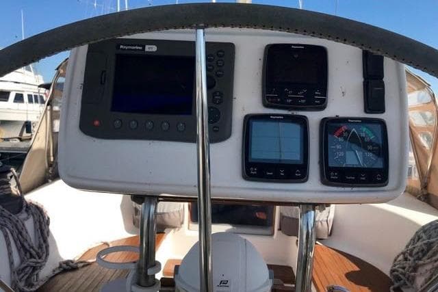 Cockpit of 1998 Dufour 45 Classic sailboat with navigation instruments and steering wheel.