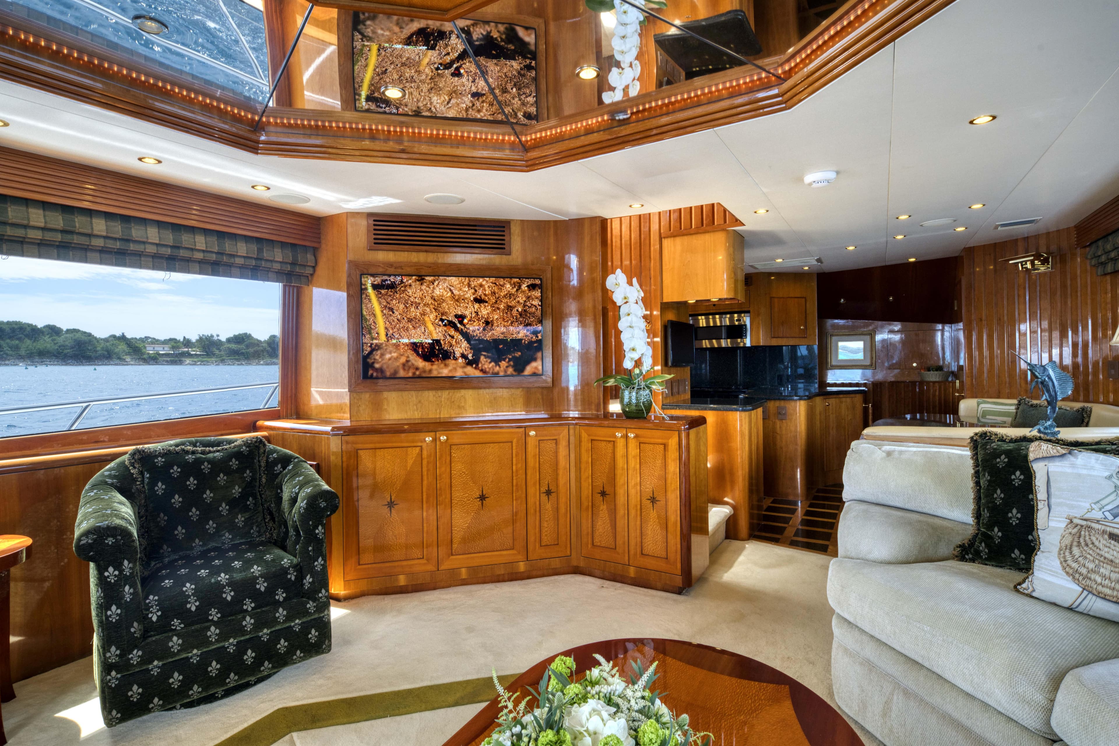 Luxurious interior of 2003 Hatteras 86 Convertible yacht with elegant wood paneling.