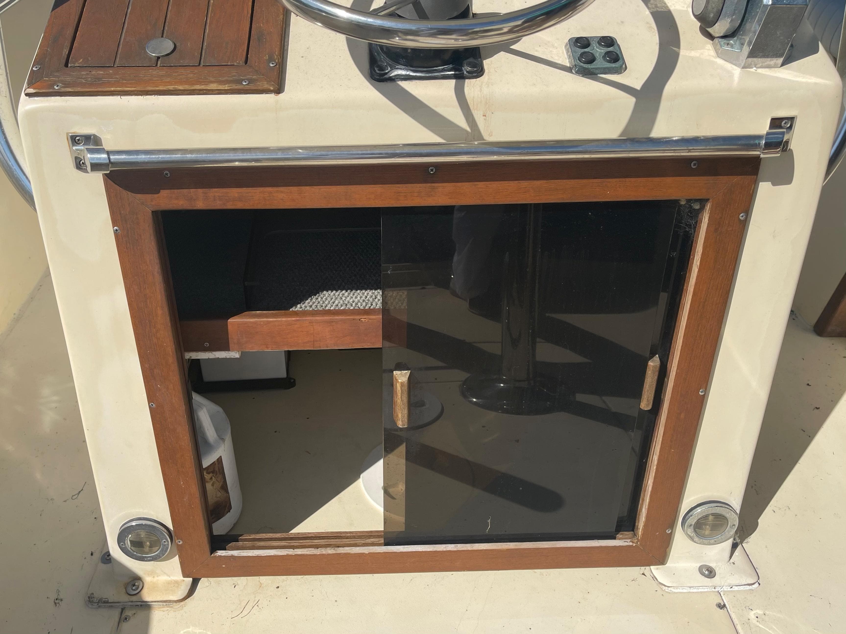 1986 Gulf Stream Yachts custom model helm station with wooden storage cabinet.