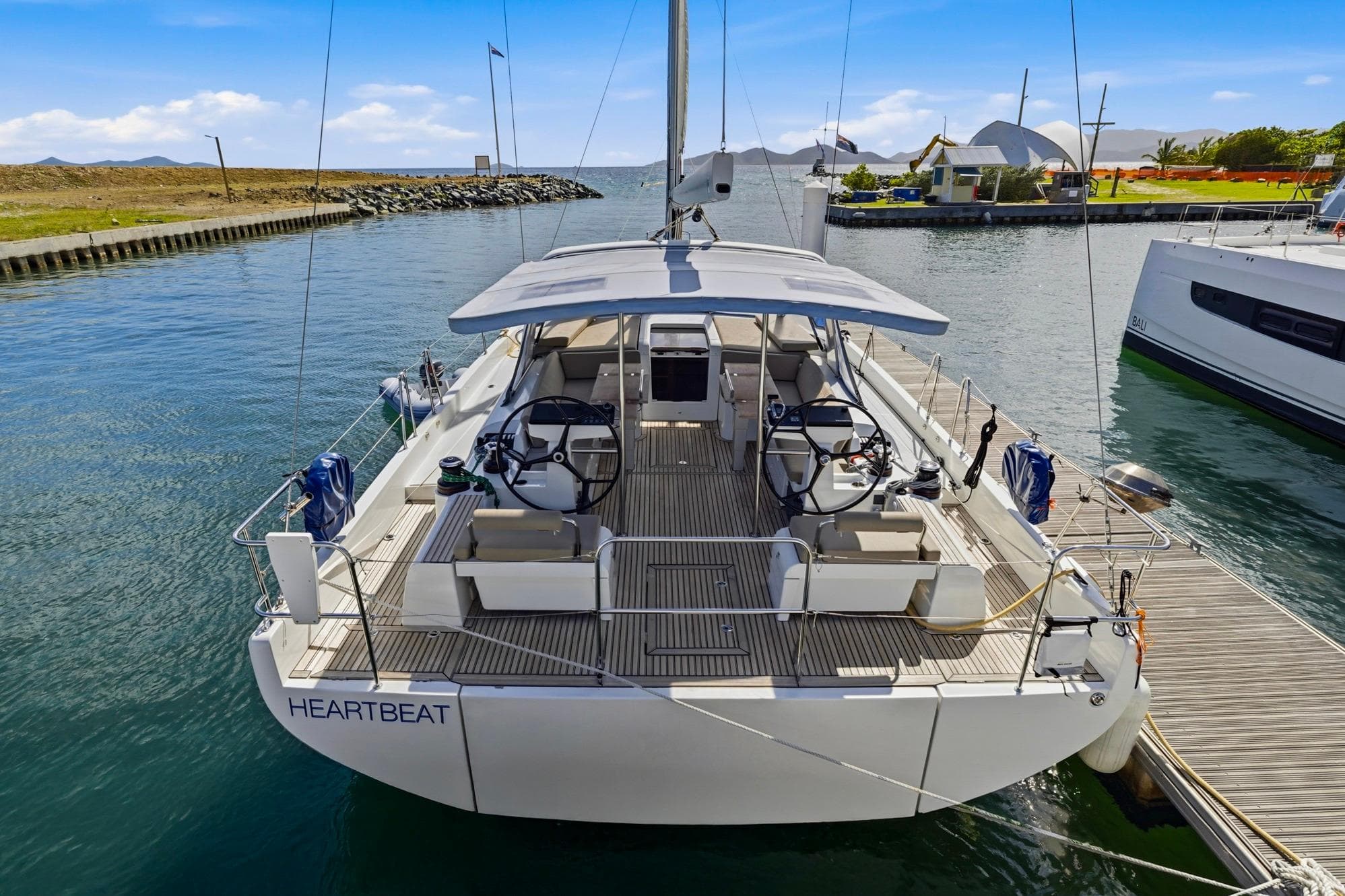 2024 Beneteau Oceanis Yacht 54 docked, showcasing sleek design and spacious deck.
