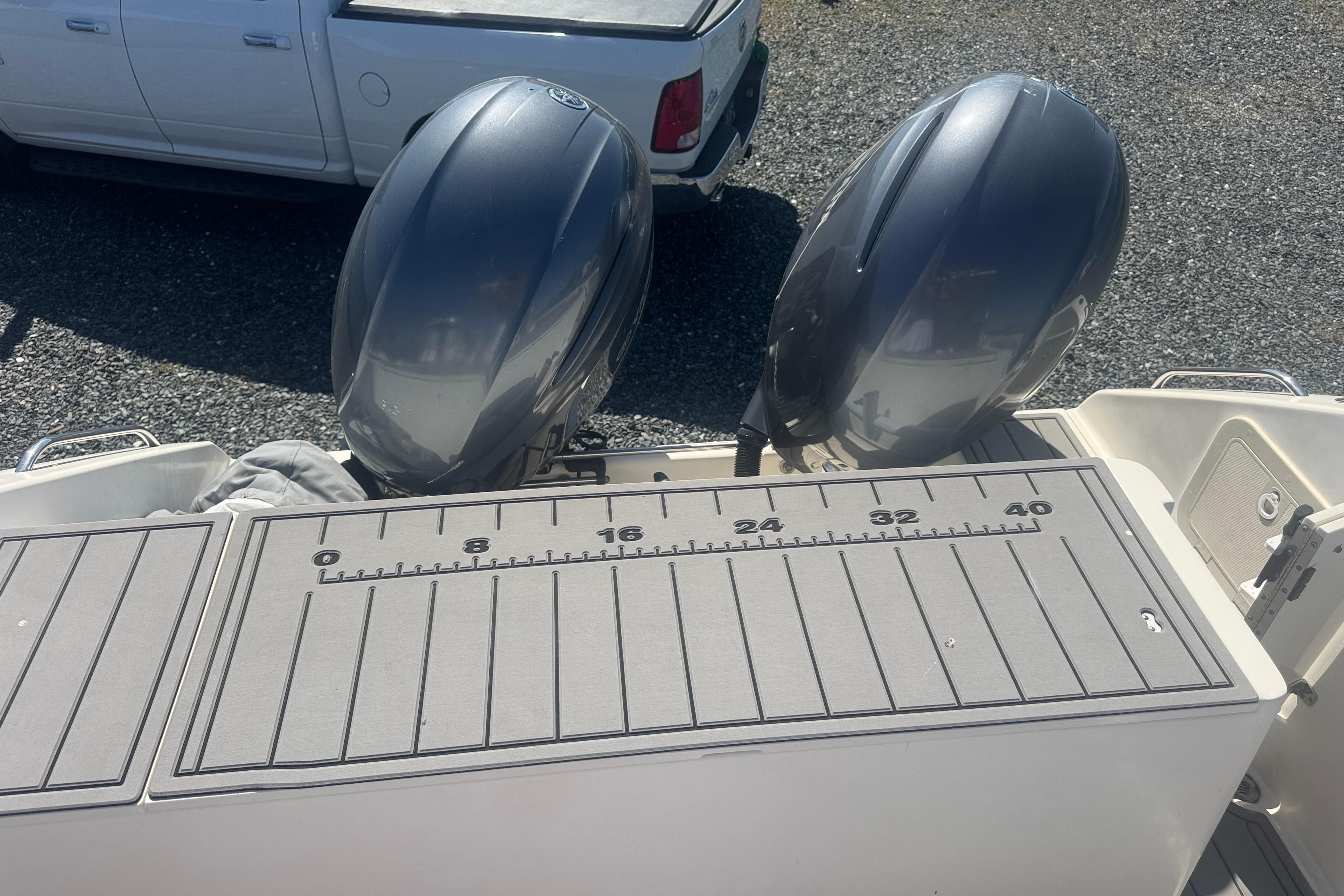 2000 Pursuit 2870 Offshore Center Console with dual outboard motors and measuring board.