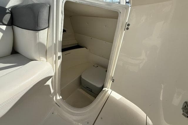Interior view of a 2015 Bayliner 210 Deck Boat's compact cabin space.