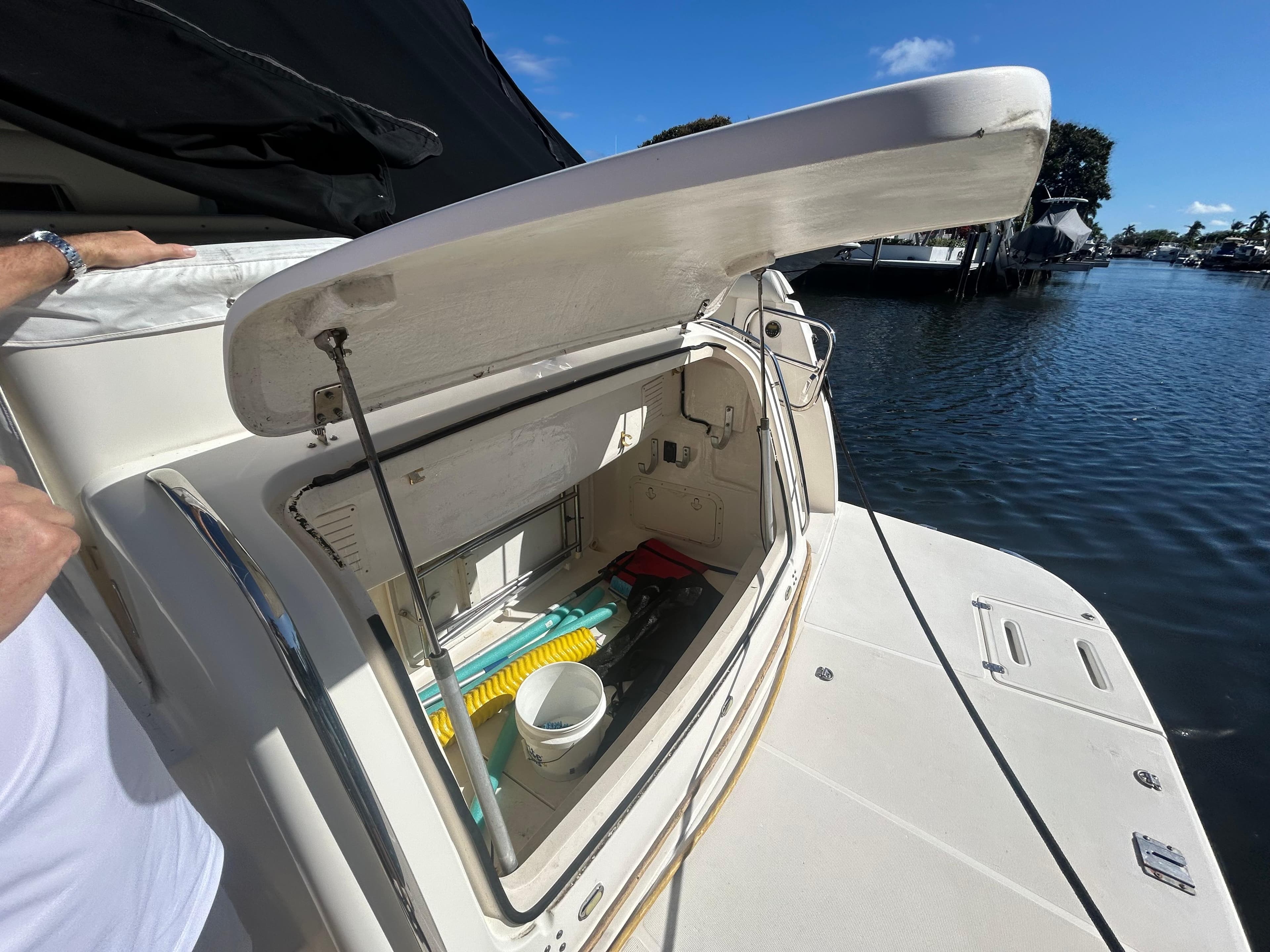 Open storage compartment on a 1998 Tiara Yachts 3500 Express by the water.