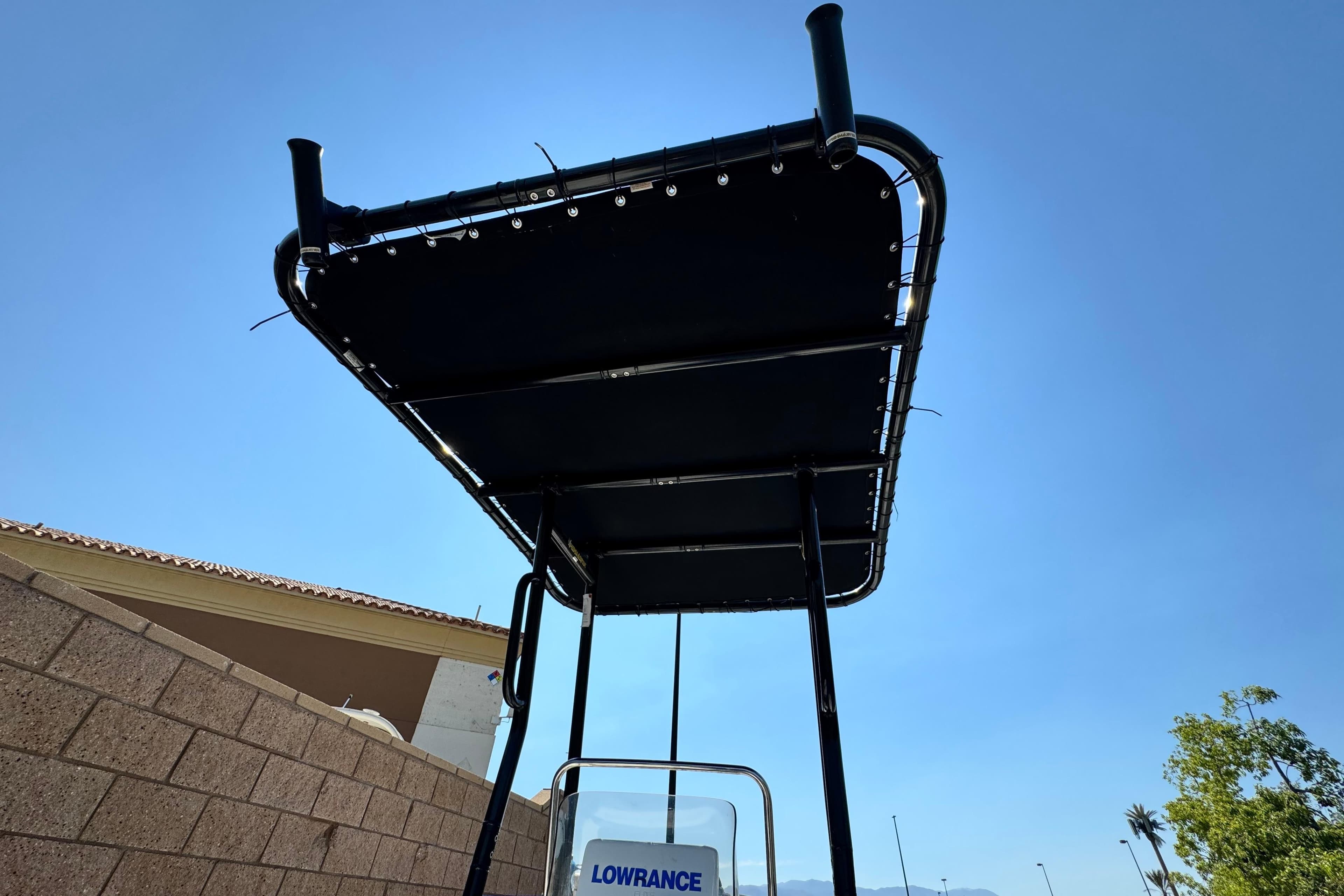 T-top canopy on a 2017 Mako Pro Skiff 17 CC against a clear blue sky.