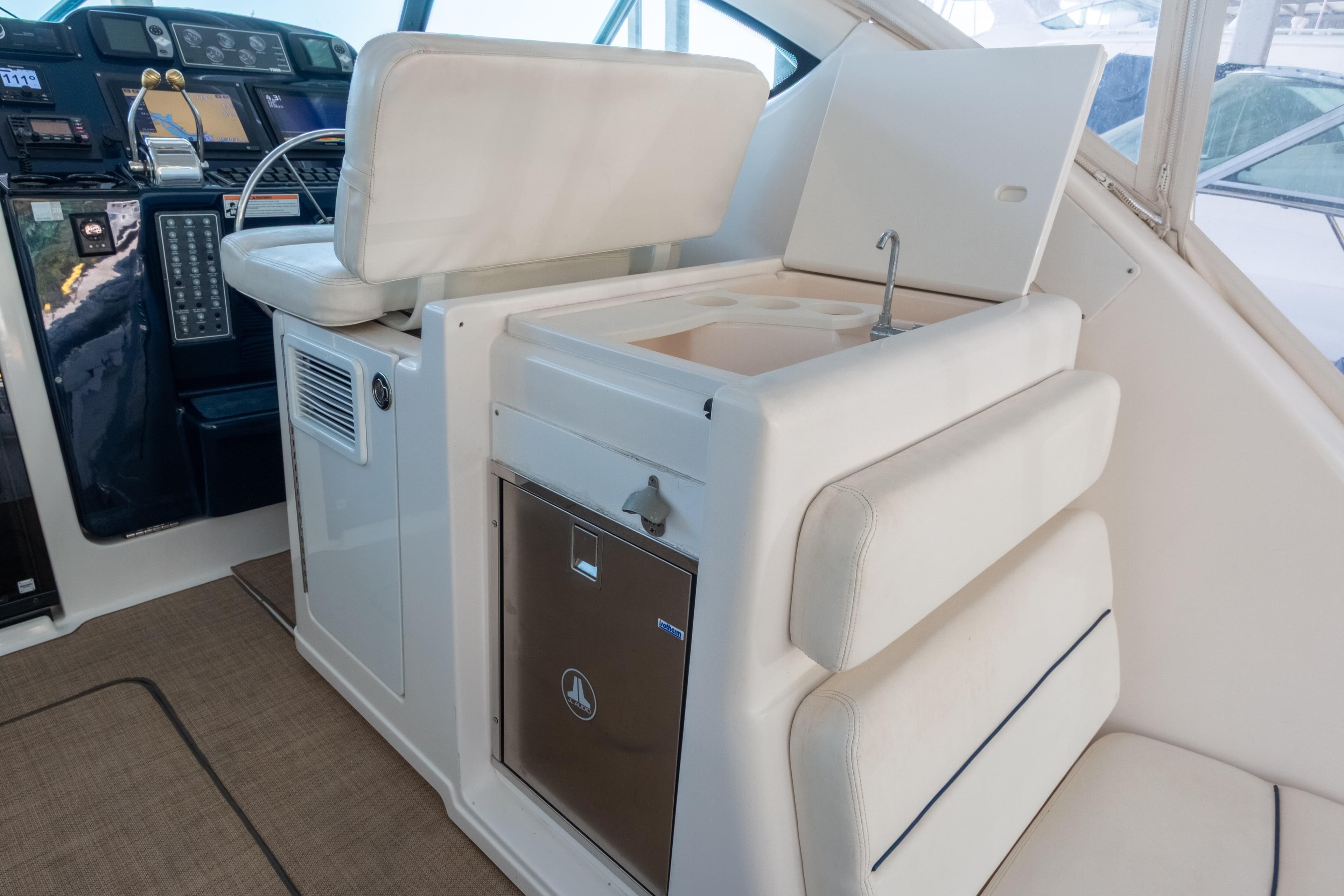 2007 Tiara Yachts 3800 Open interior with helm, seating, and compact kitchenette.