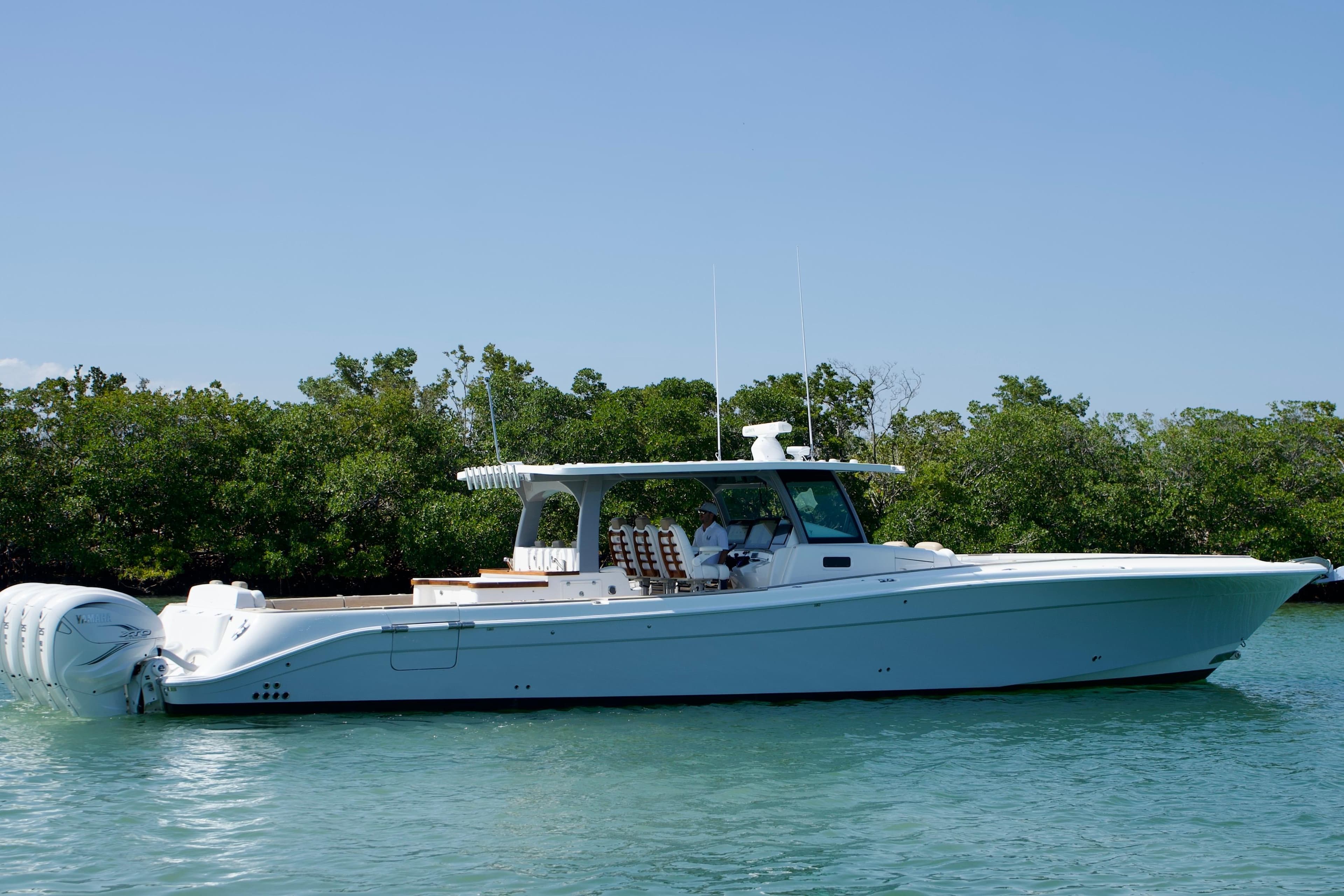 2019 HCB 53 Suenos boat on calm water with lush greenery background.