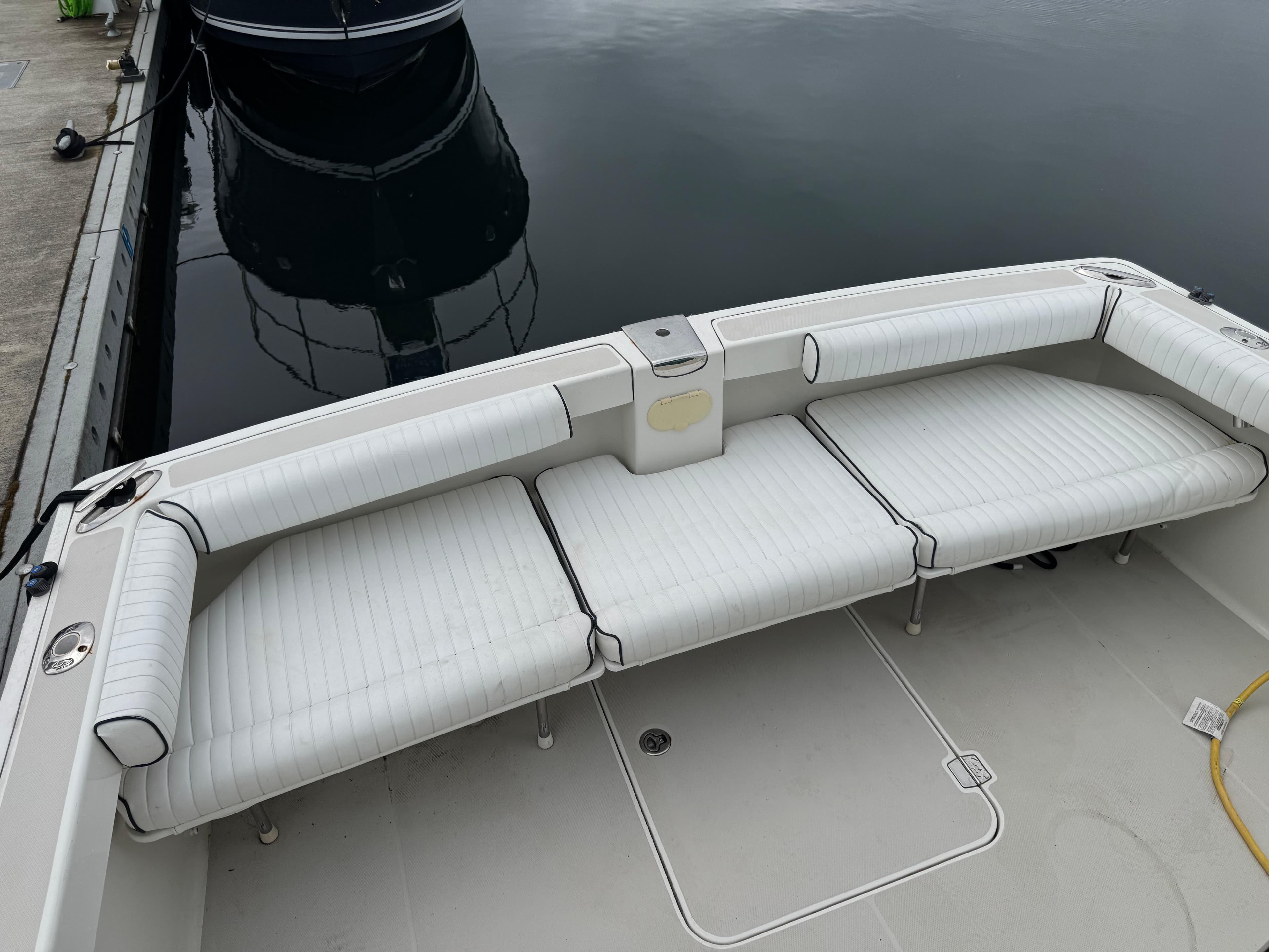 2008 Back Cove 29 Hardback boat with white cushioned seating at the dock.