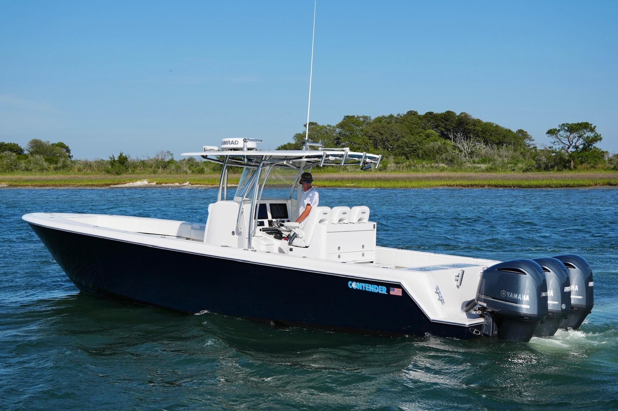 2019 Contender 35 ST boat with triple Yamaha engines cruising on a sunny day.