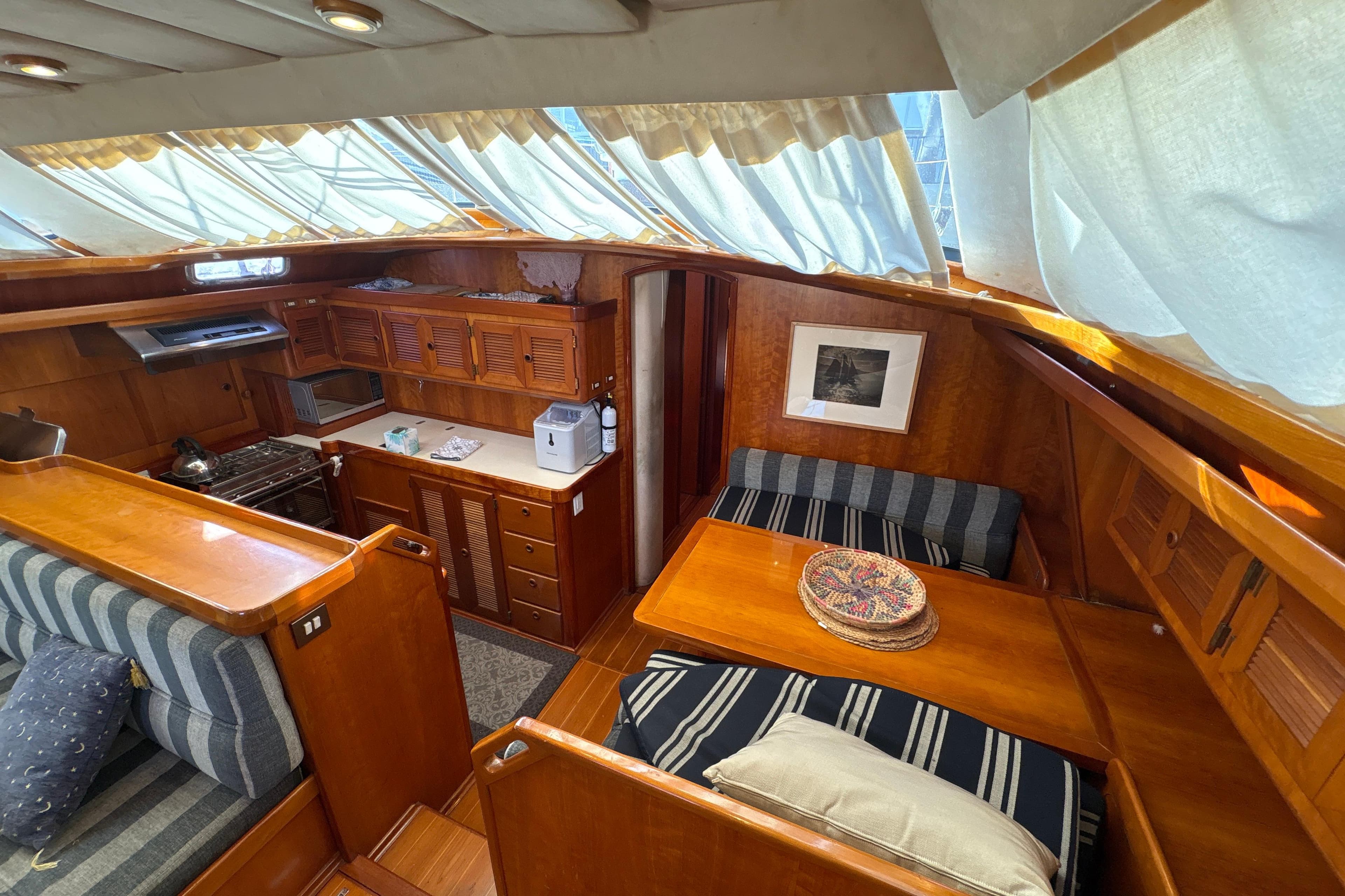 Luxurious interior of a 2001 North Wind 56 yacht with wood finishes and cozy seating.