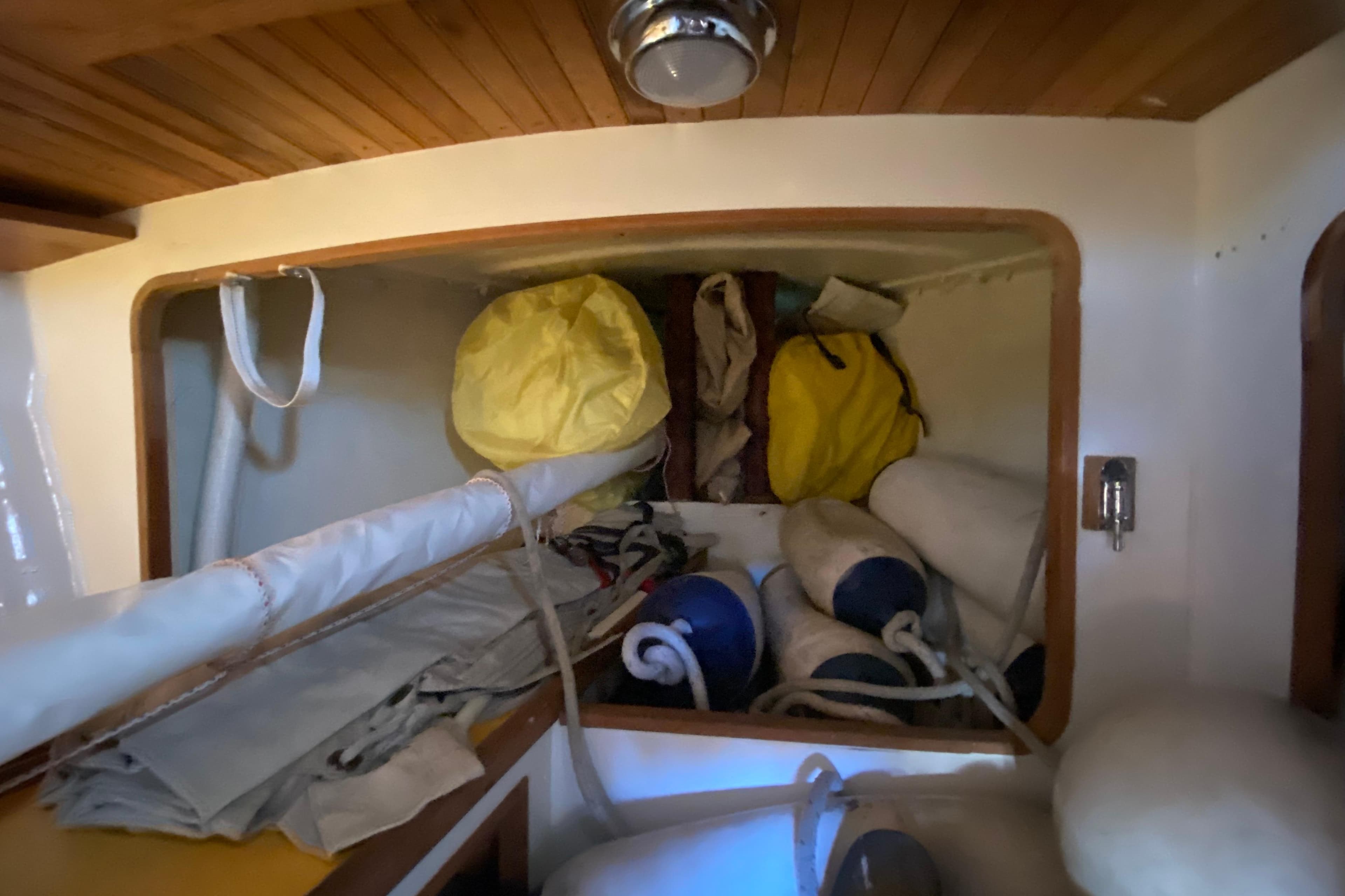 Interior storage of 1978 Bristol Channel Cutter 28 with sails and equipment.
