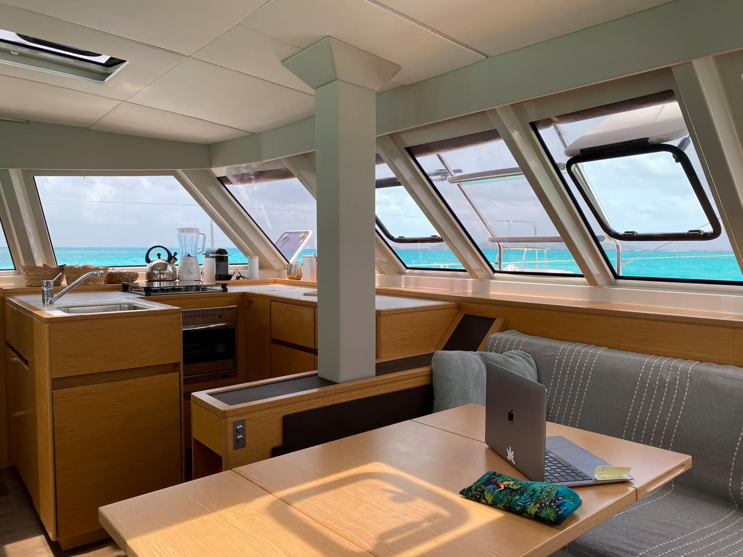 Interior of 2018 Nautitech 46 Open catamaran with kitchen and seating area, ocean view.