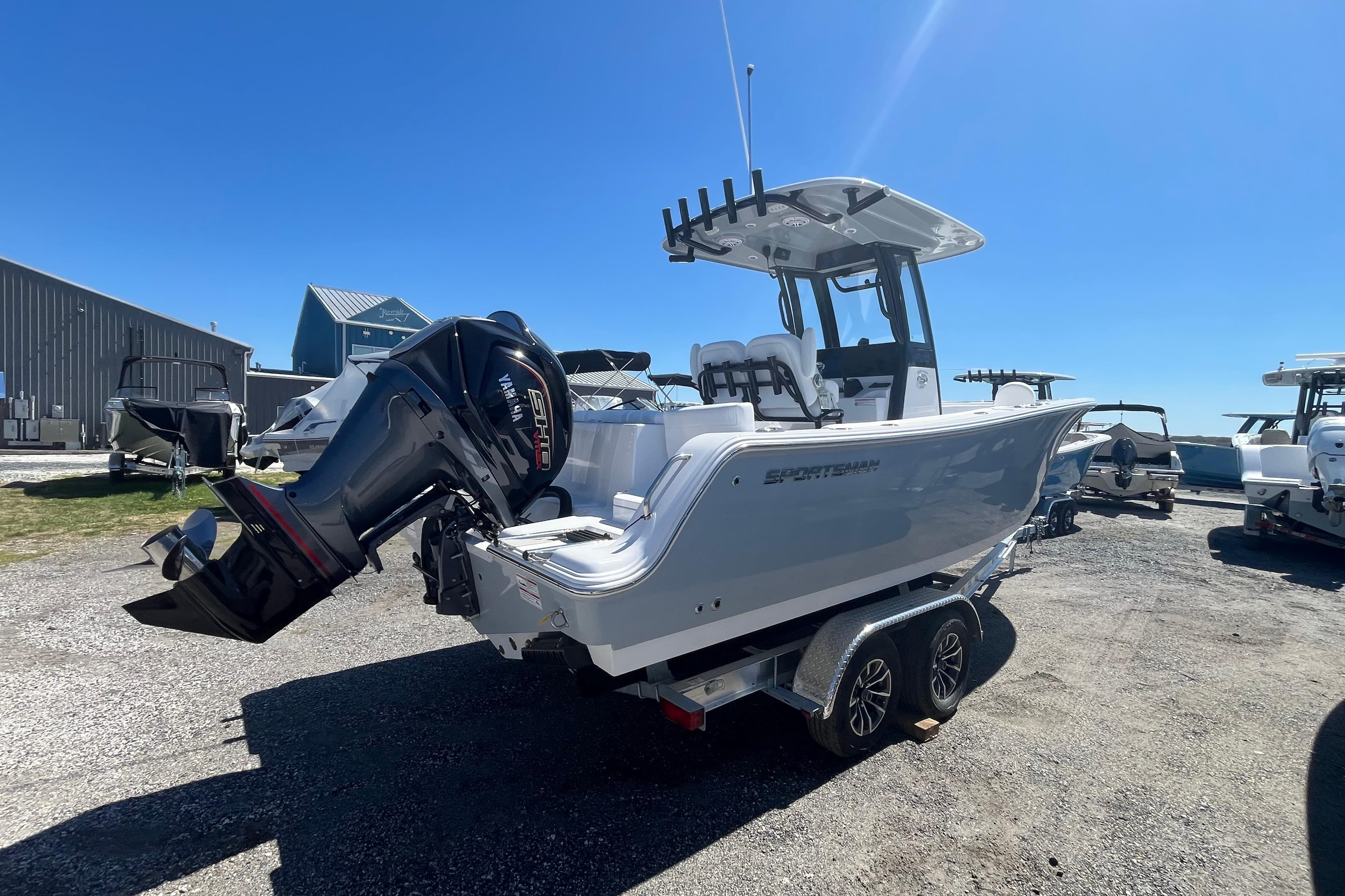 2026 Sportsman Heritage 231 Center Console boat on trailer, sunny day.