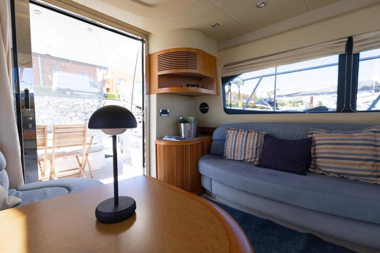 Interior of a 2005 Azimut 46 yacht with cozy seating and modern decor.