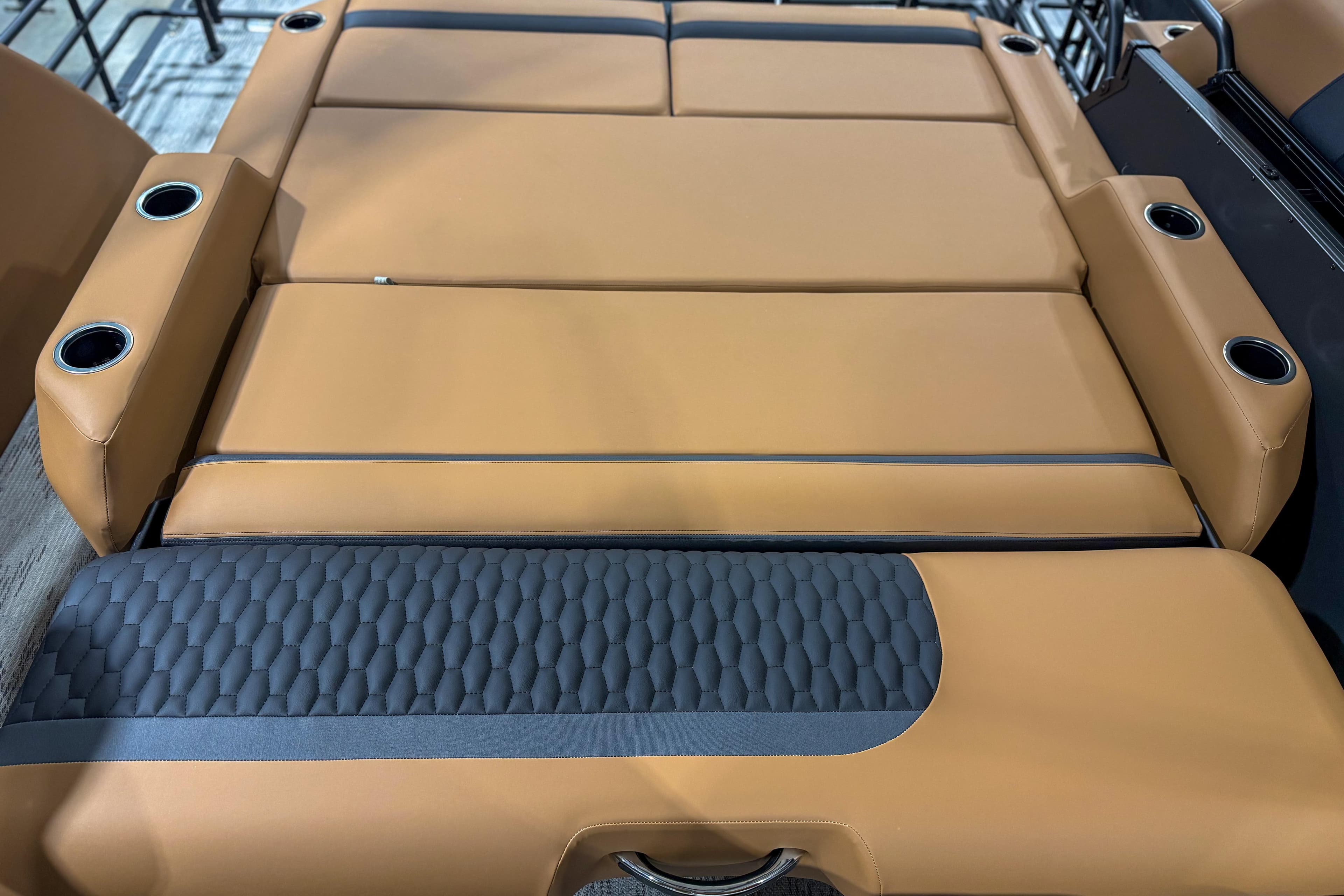 Luxurious tan seating with cup holders in 2026 Sylvan L3 ULZ boat interior.
