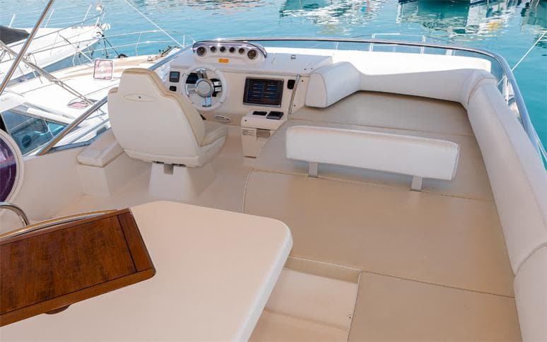 Flybridge of 2011 Azimut 48 yacht with helm and seating area.