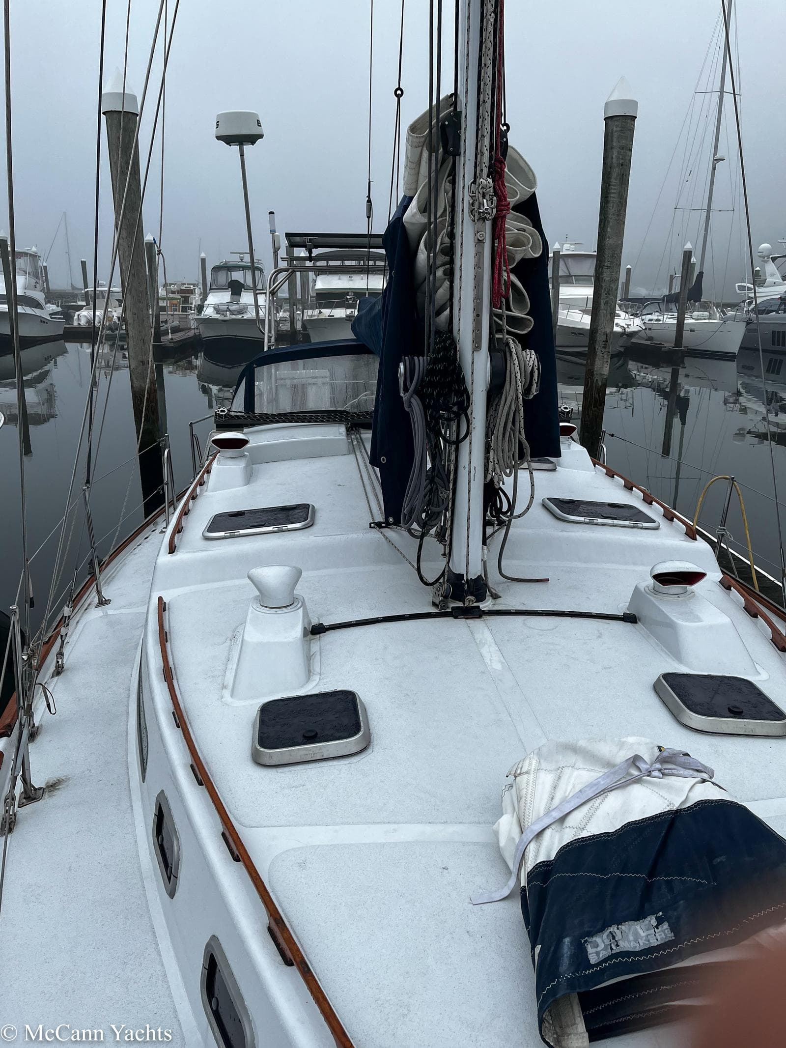 1973 Challenger 40 sailboat docked in a foggy marina, showcasing deck and rigging.