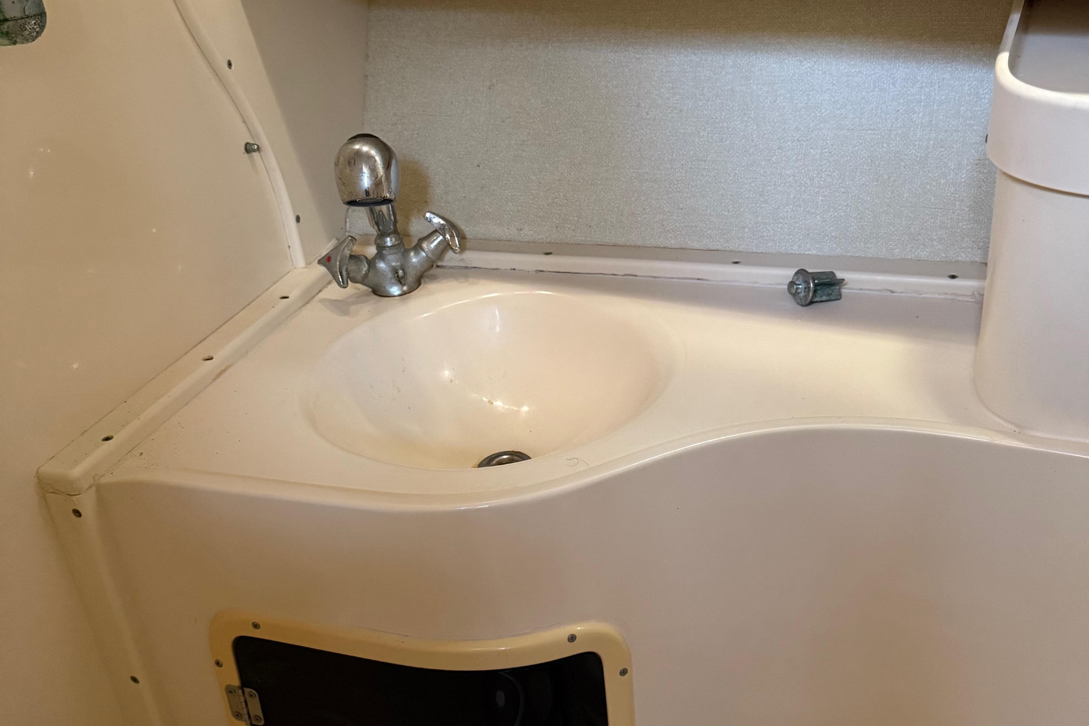 1996 Grady-White Marlin 300 boat sink with chrome faucet in cabin area.