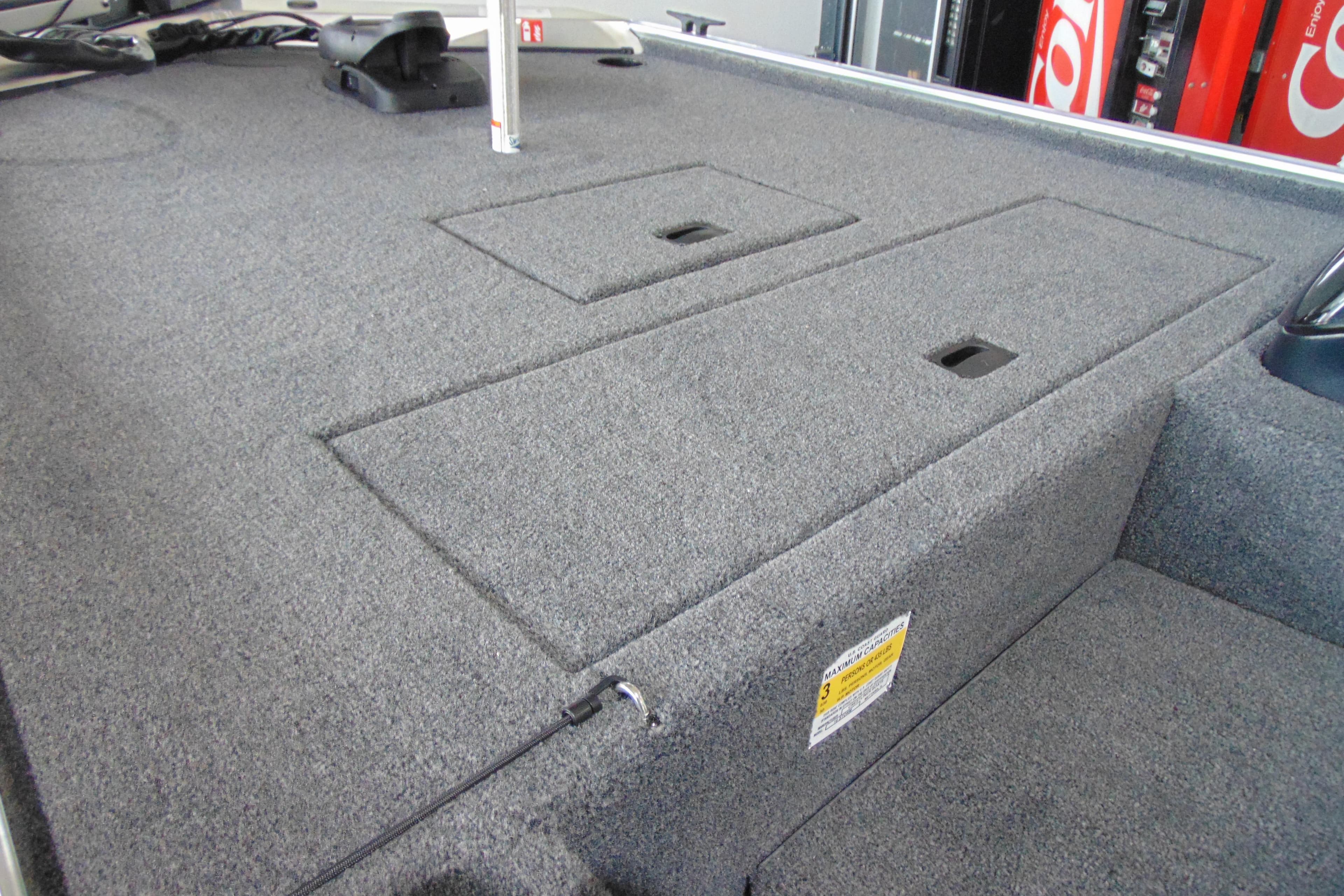 2026 Crestliner 1600 Storm boat interior with carpeted storage compartments.