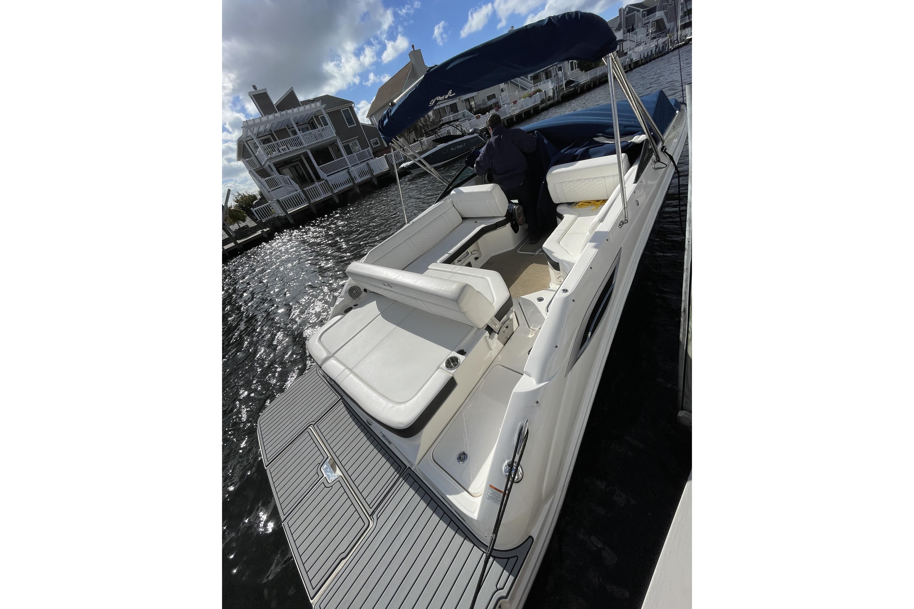 2018 Sea Ray SDX 250 boat docked, featuring spacious seating and sleek design.