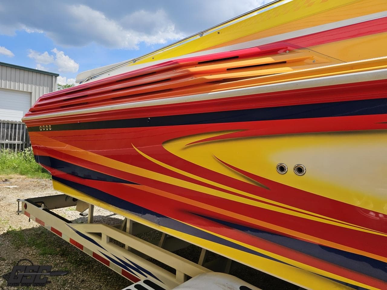 Colorful 2004 Sonic USA 45SS boat with vibrant red, yellow, and blue design.