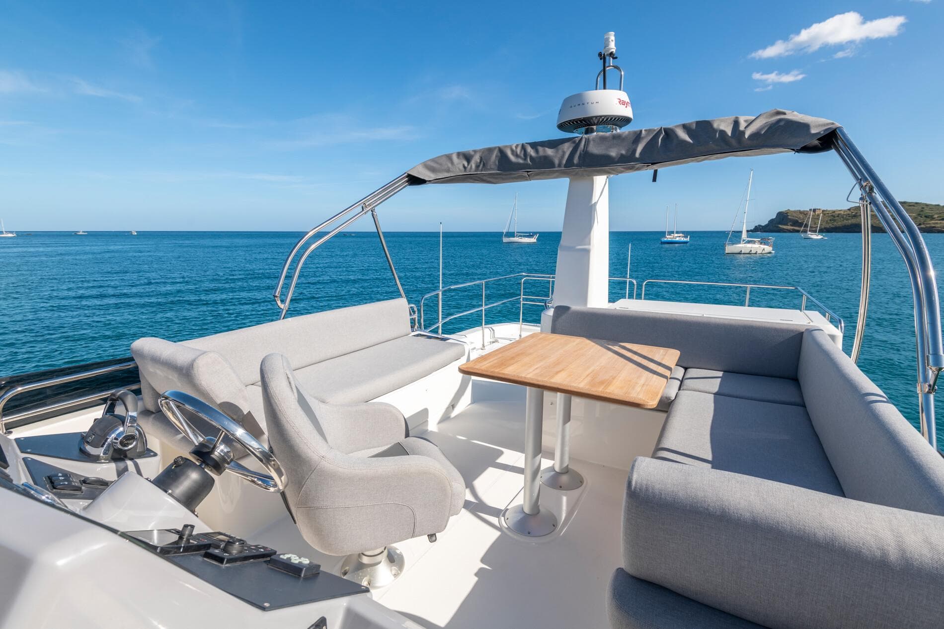 2025 Beneteau Swift Trawler 41 Fly, spacious flybridge with seating, ocean view.