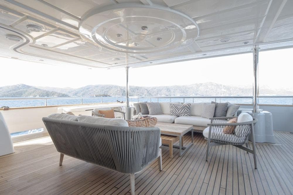 Luxurious CRN 129 yacht deck with elegant seating, ocean view, and modern design, built in 2009.