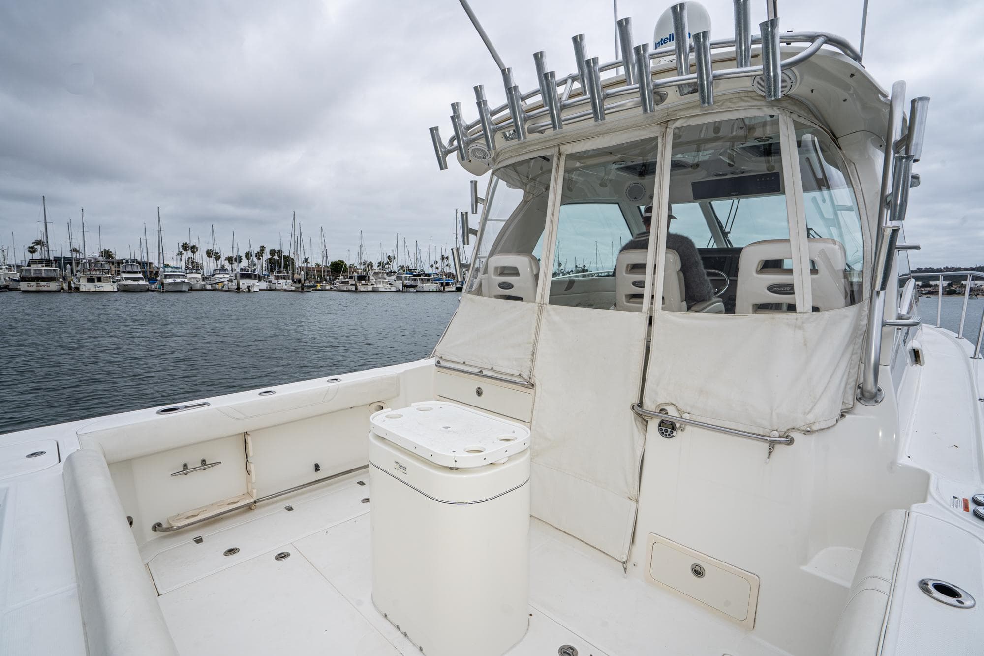 2009 Boston Whaler 345 Conquest boat docked in marina, overcast sky, spacious deck area.