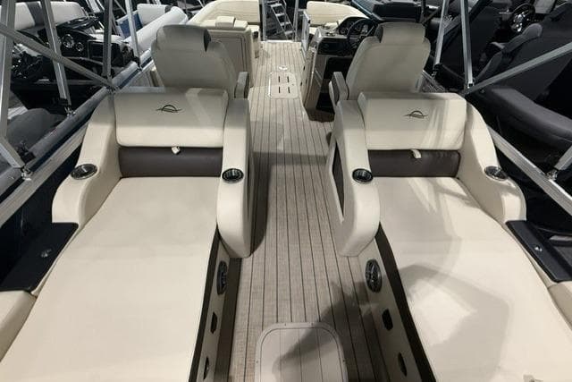 Luxurious interior of 2026 SunCatcher Fusion 322SS boat with plush seating and sleek design.