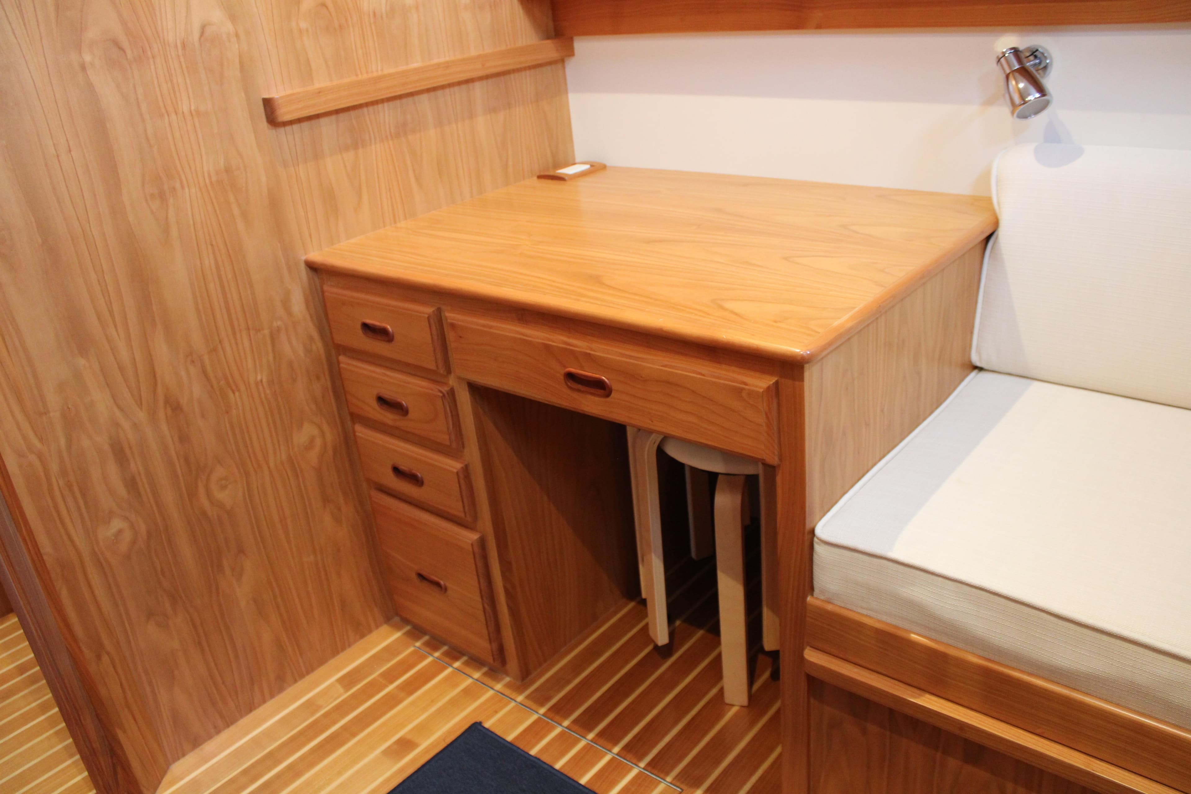 2023 Krogen Express 52' yacht interior with wooden desk and seating area.