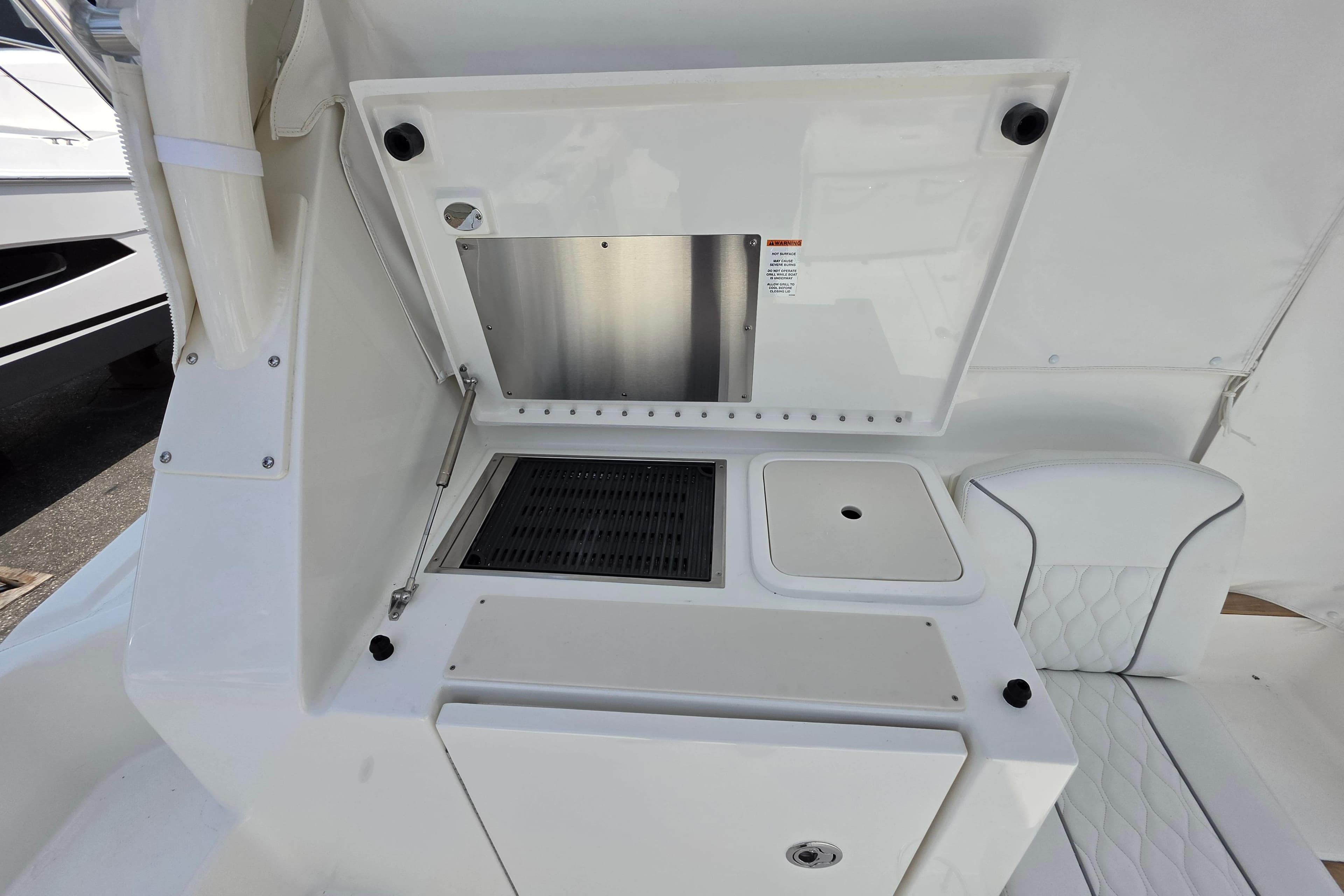 2026 Pursuit OS 355 Offshore boat interior with sleek white seating and built-in storage.