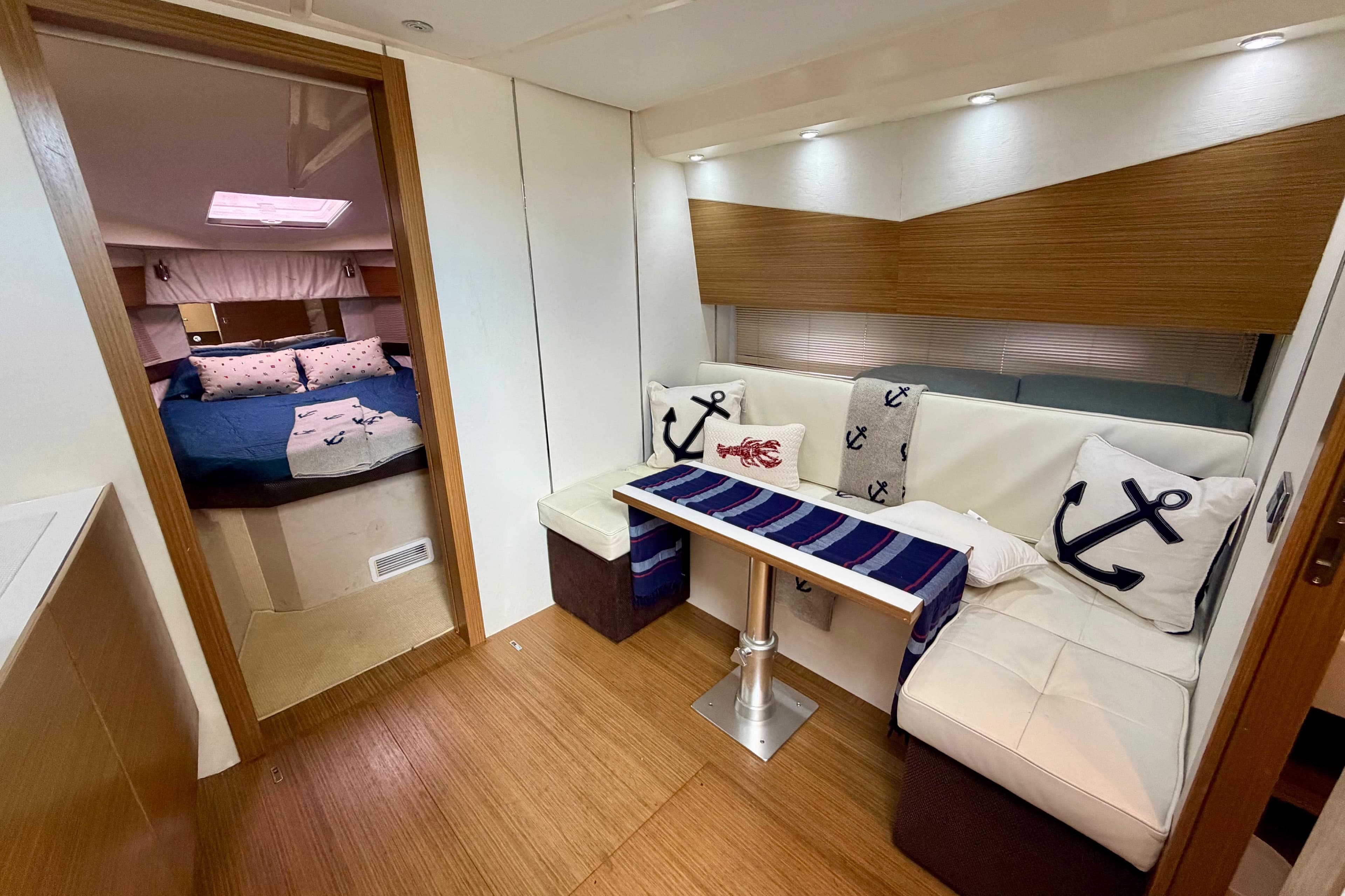 Interior of 2014 Azimut Verve 40 yacht with cozy seating and nautical decor.