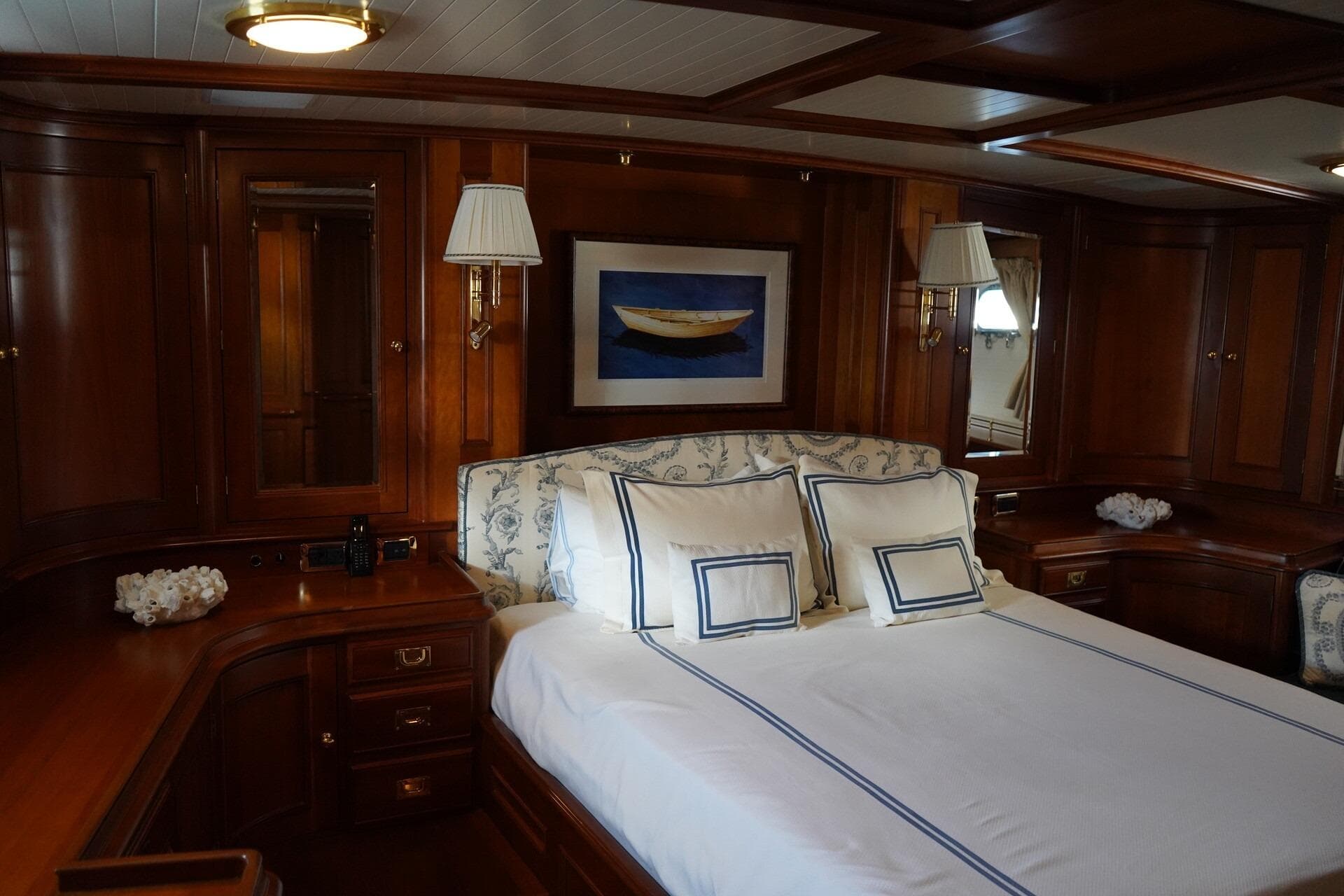 Luxurious 1992 Palmer Johnson Cruising Ketch cabin with elegant wood paneling and nautical decor.