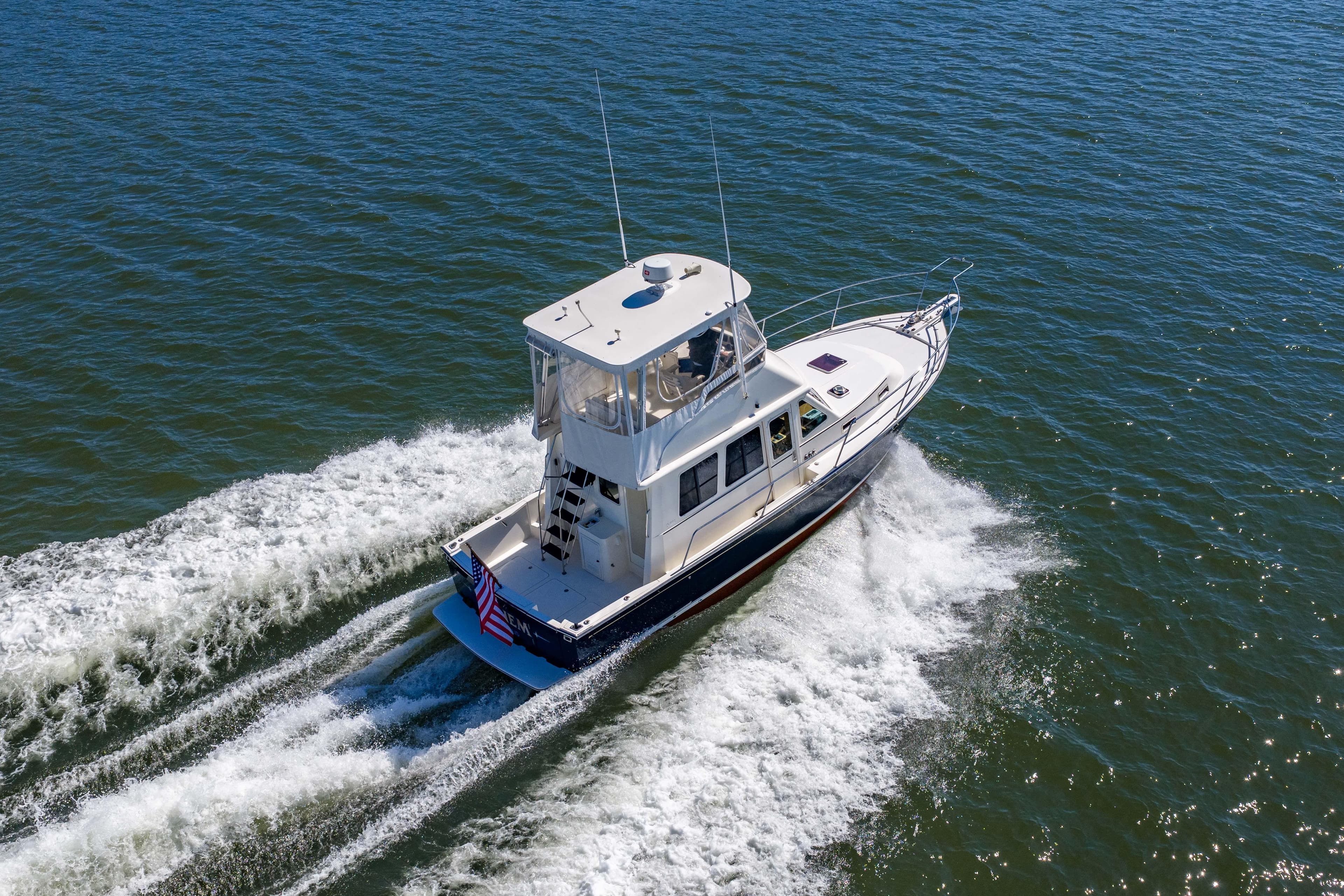 2006 Sabreline 36 Fly cruising on open water, aerial view.
