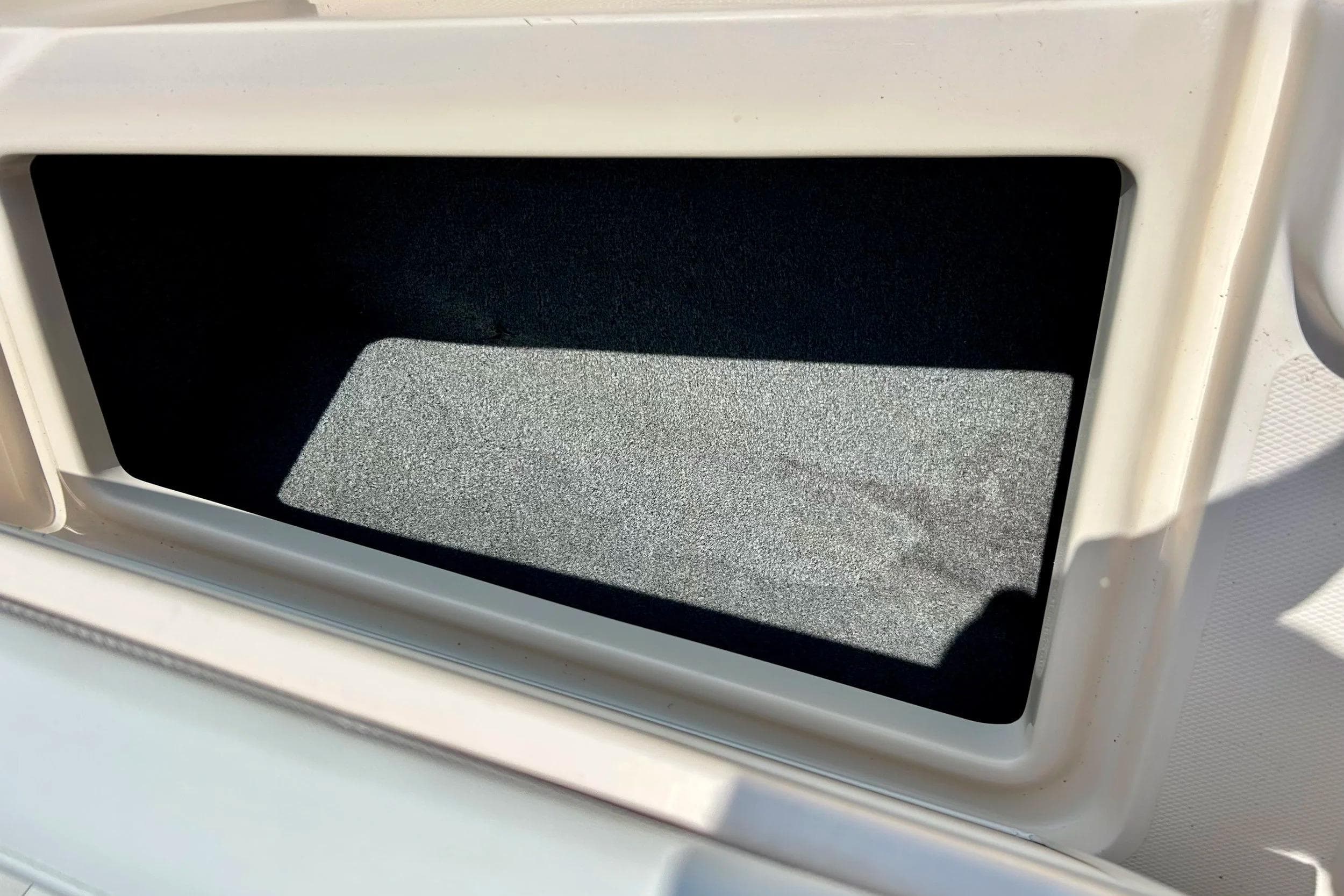 Storage compartment on a 2006 Grady White 225 Dual Console boat.