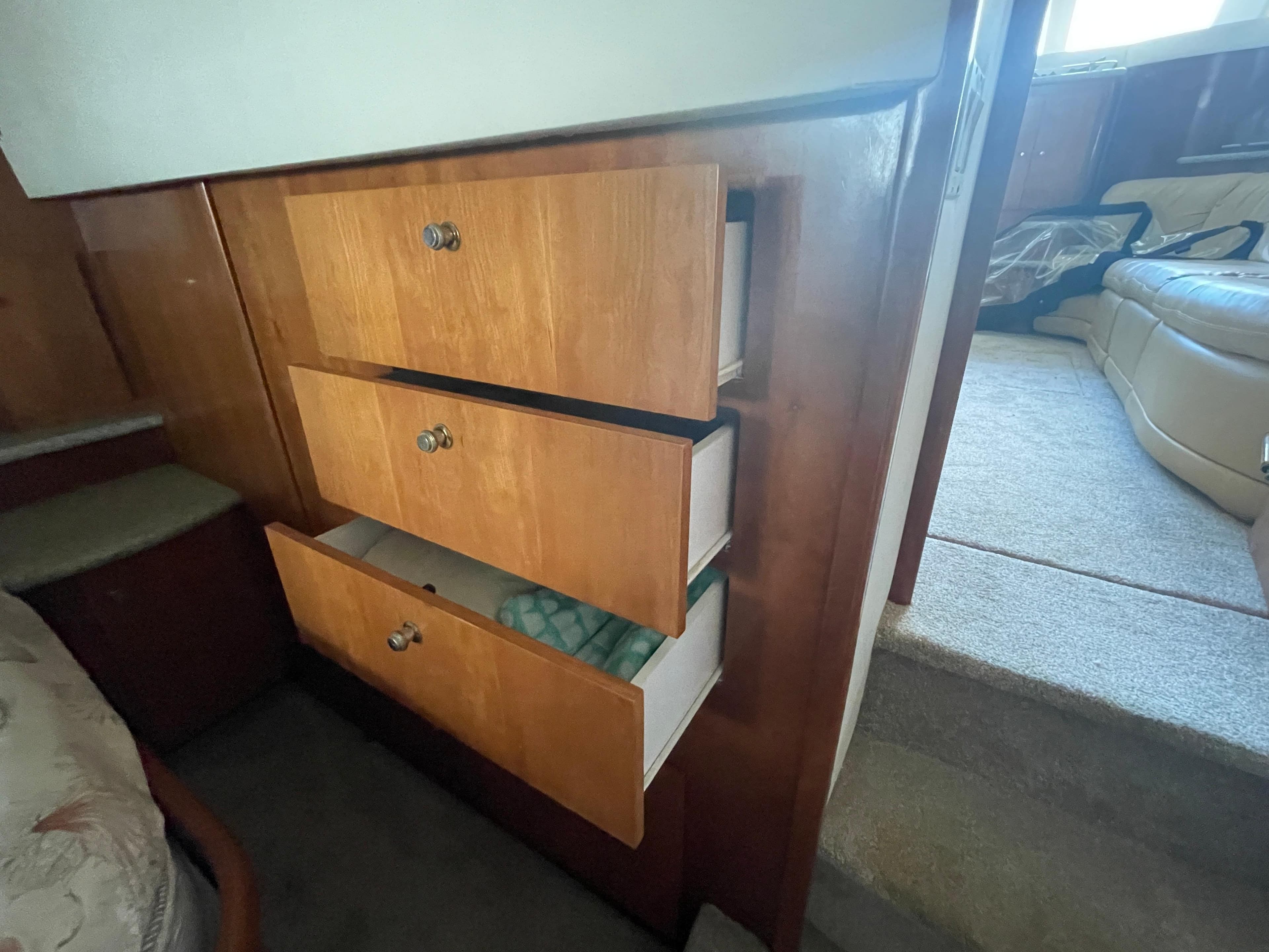 Interior view of 2001 Carver 444 Cockpit Motor Yacht with open wooden drawers.