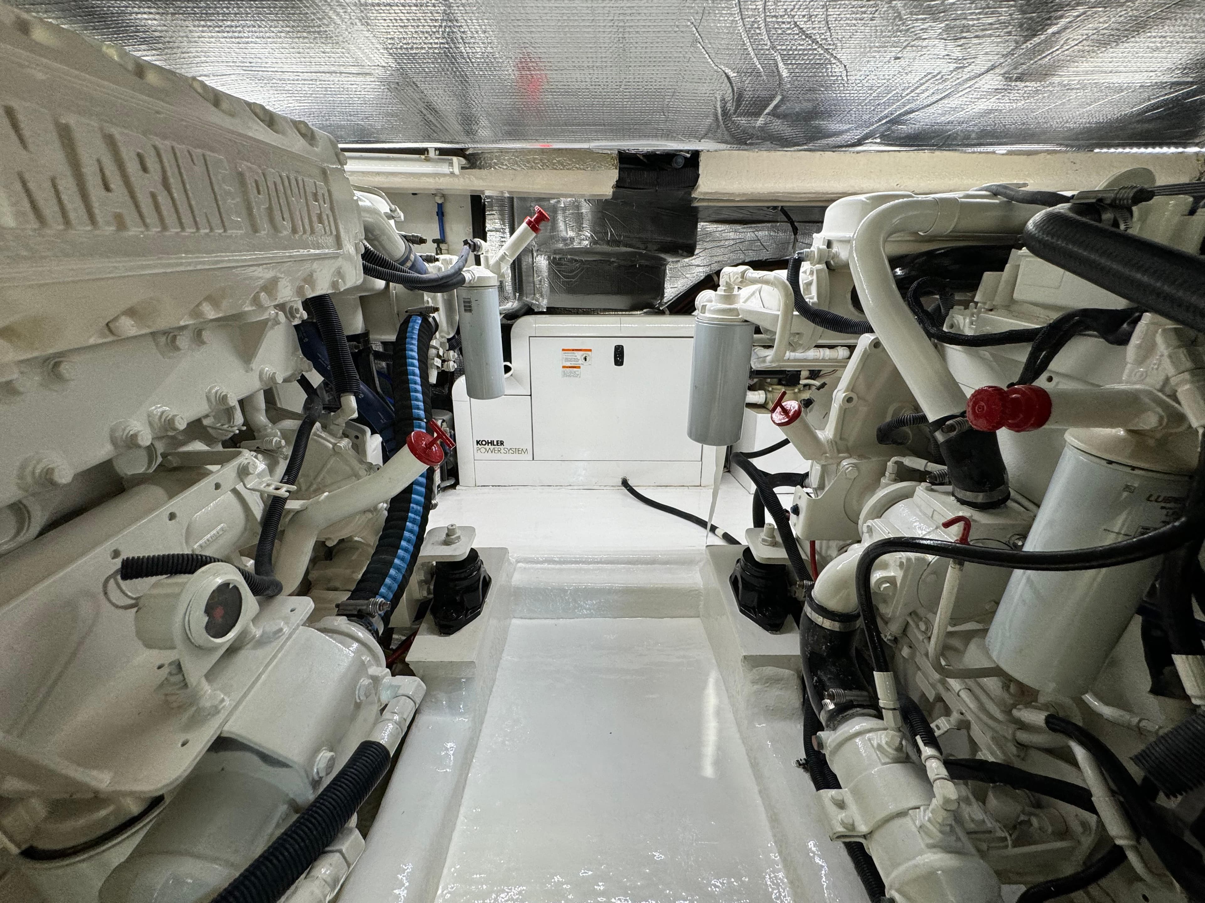 Engine room of 2003 Riviera 48 yacht, featuring dual marine power engines.