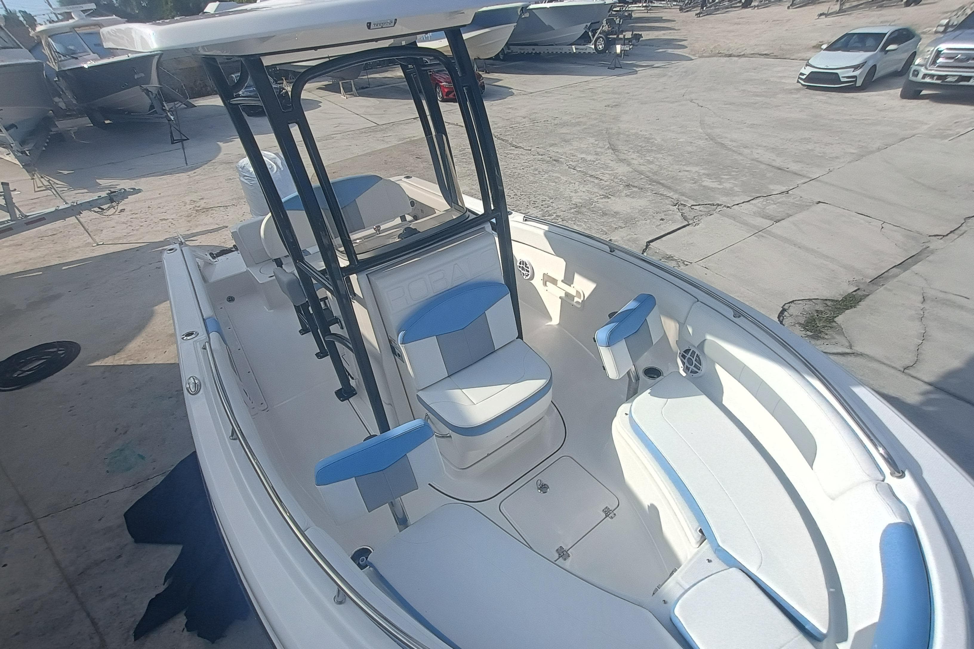 2026 Robalo R222 Center Console boat with blue and white seating, docked outdoors.