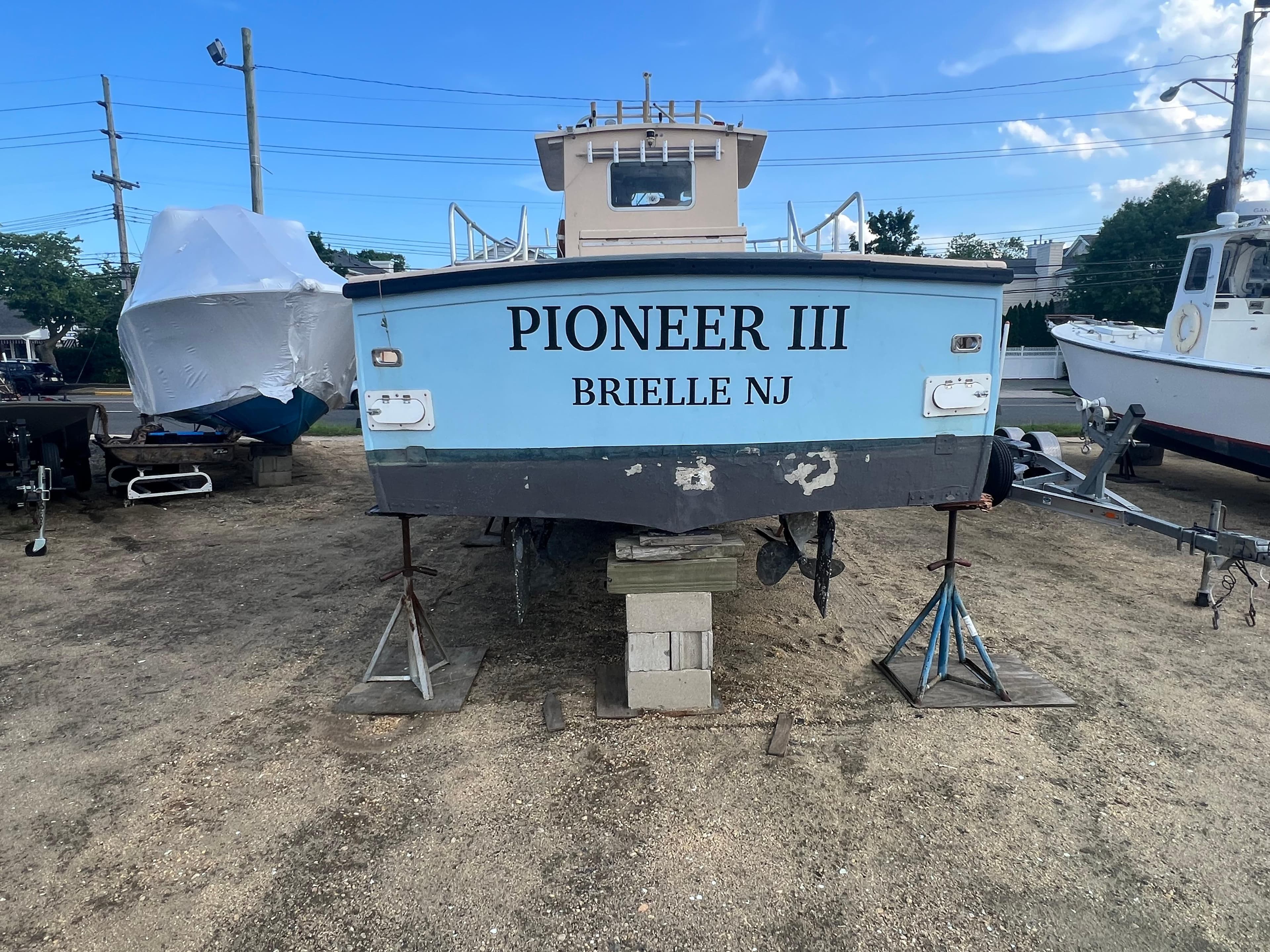 Boat named "Pioneer III" from Brielle, NJ, on land; JC 35 model, 1984.