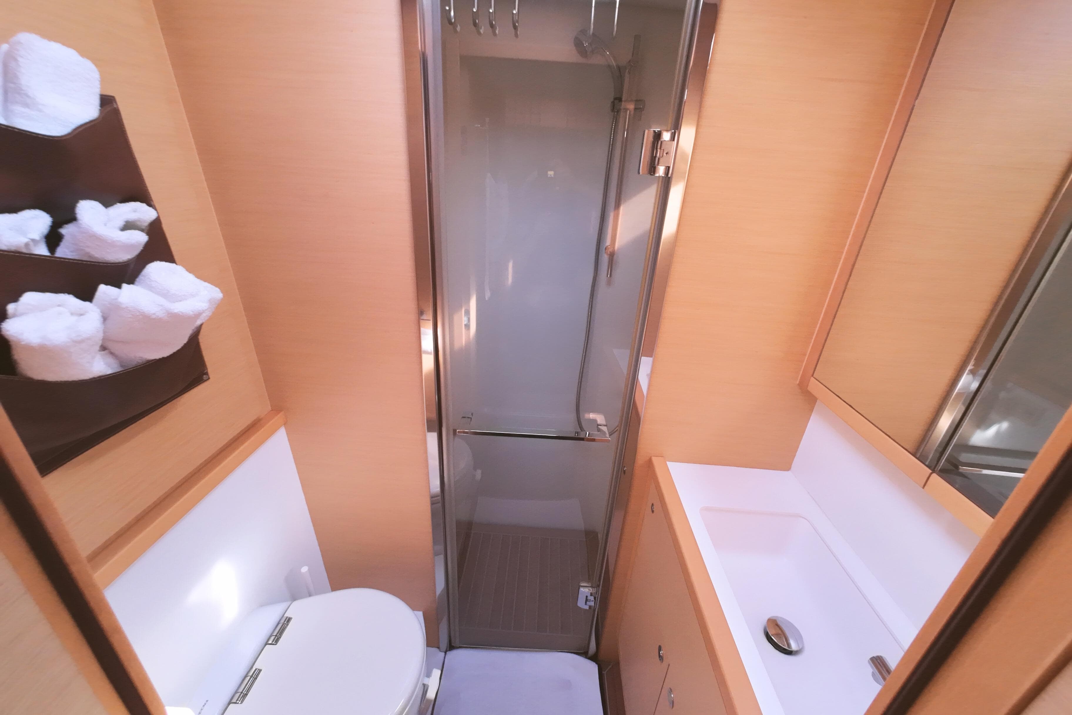 Luxurious bathroom in 2015 Lagoon 620 yacht with shower, sink, and toilet.