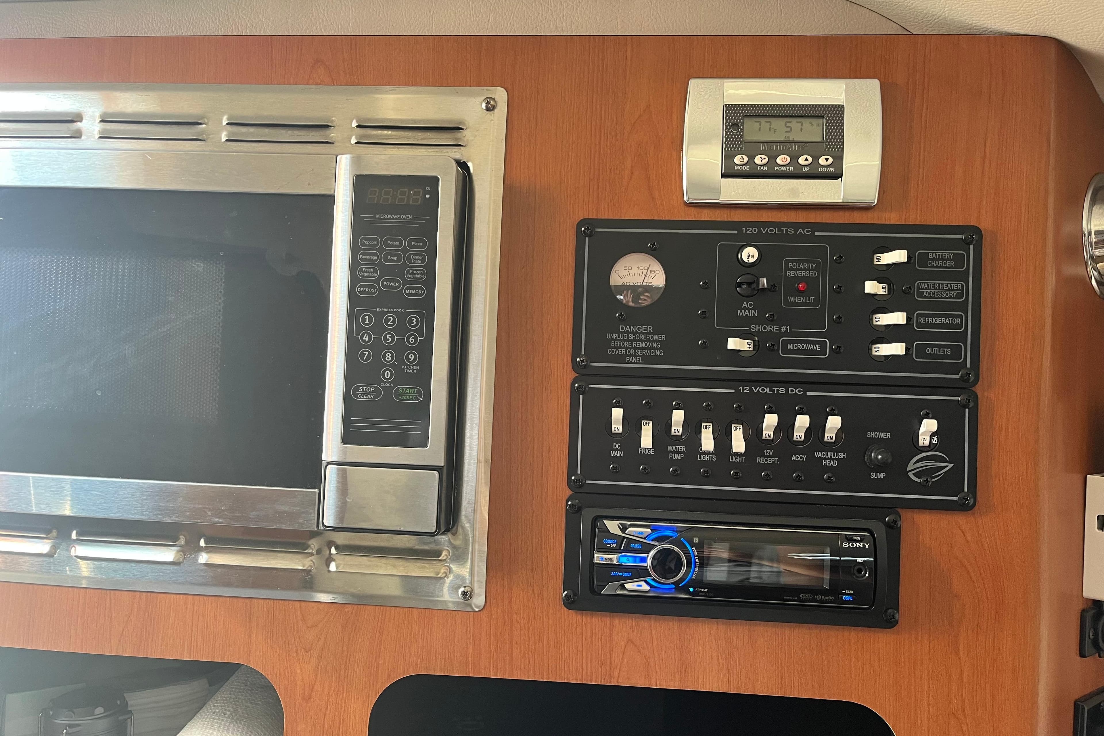Control panel and microwave in 2011 Crownline 286 SC boat interior.