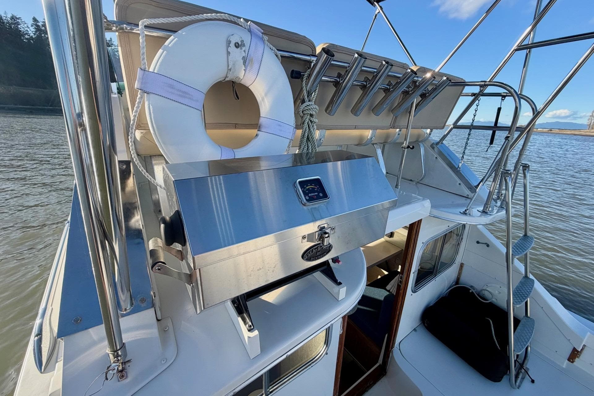 1981 Bertram 28 Flybridge Cruiser with grill and life preserver on deck.