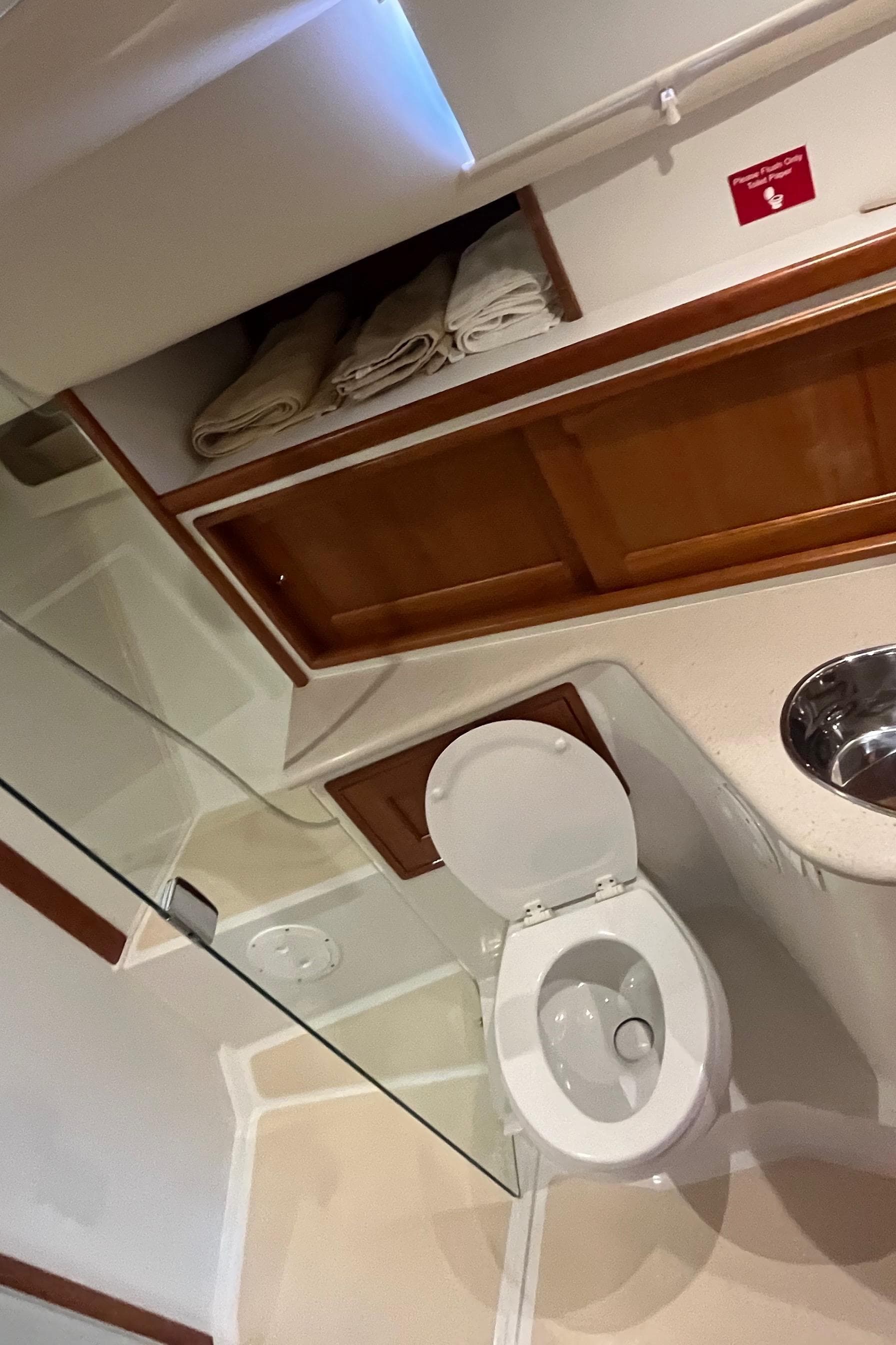 Bathroom interior of 2016 MJM 50z yacht with wooden cabinets and modern fixtures.