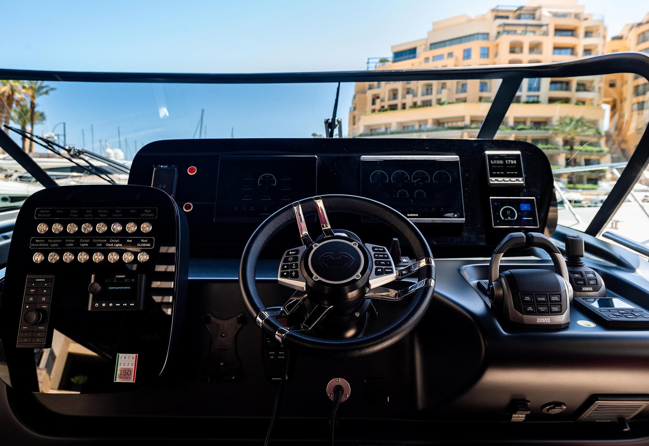 Cockpit of 2022 Cranchi A46 yacht with modern controls and steering wheel.