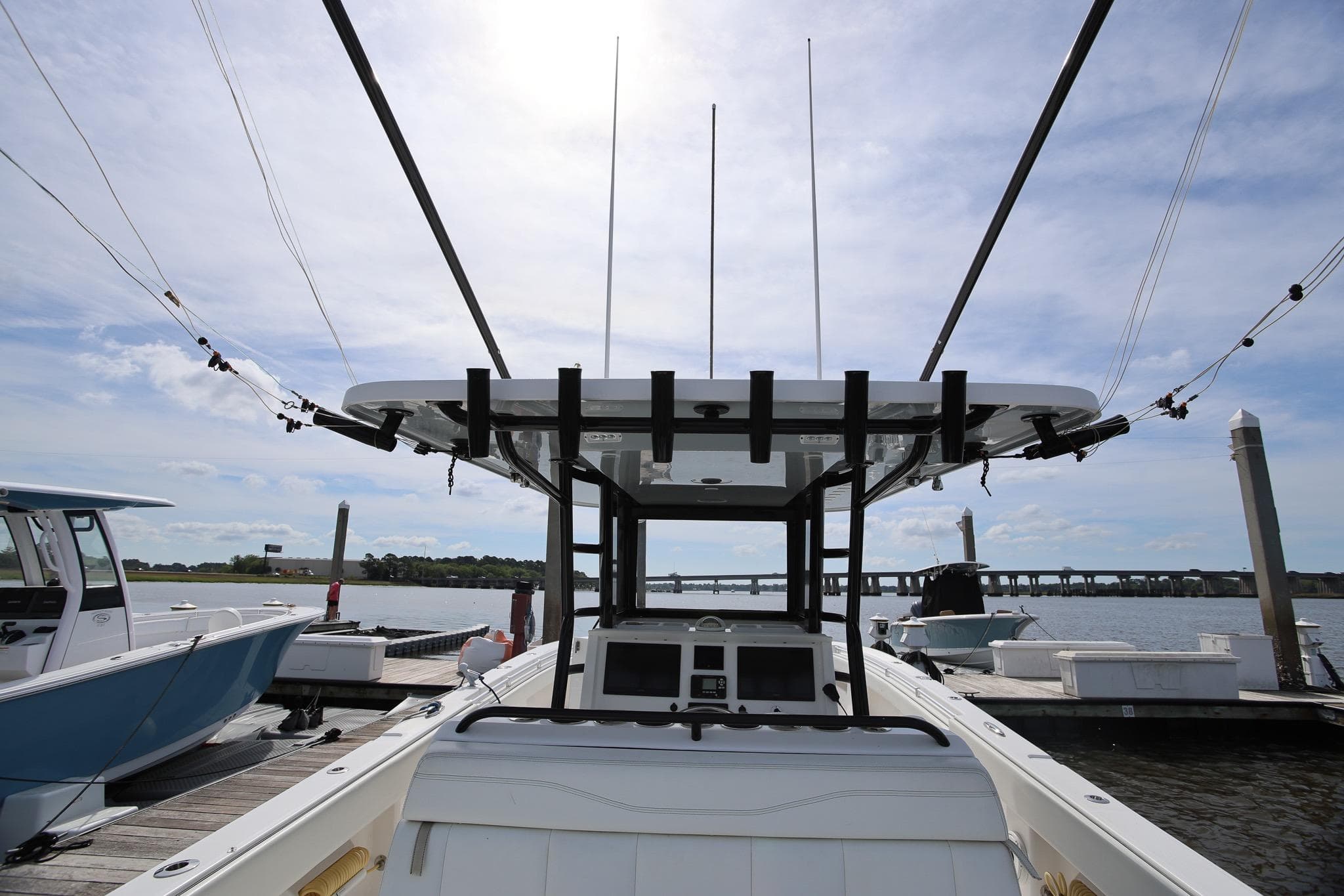 2020 Invincible 35 Catamaran docked, showcasing helm and fishing rods under a clear sky.