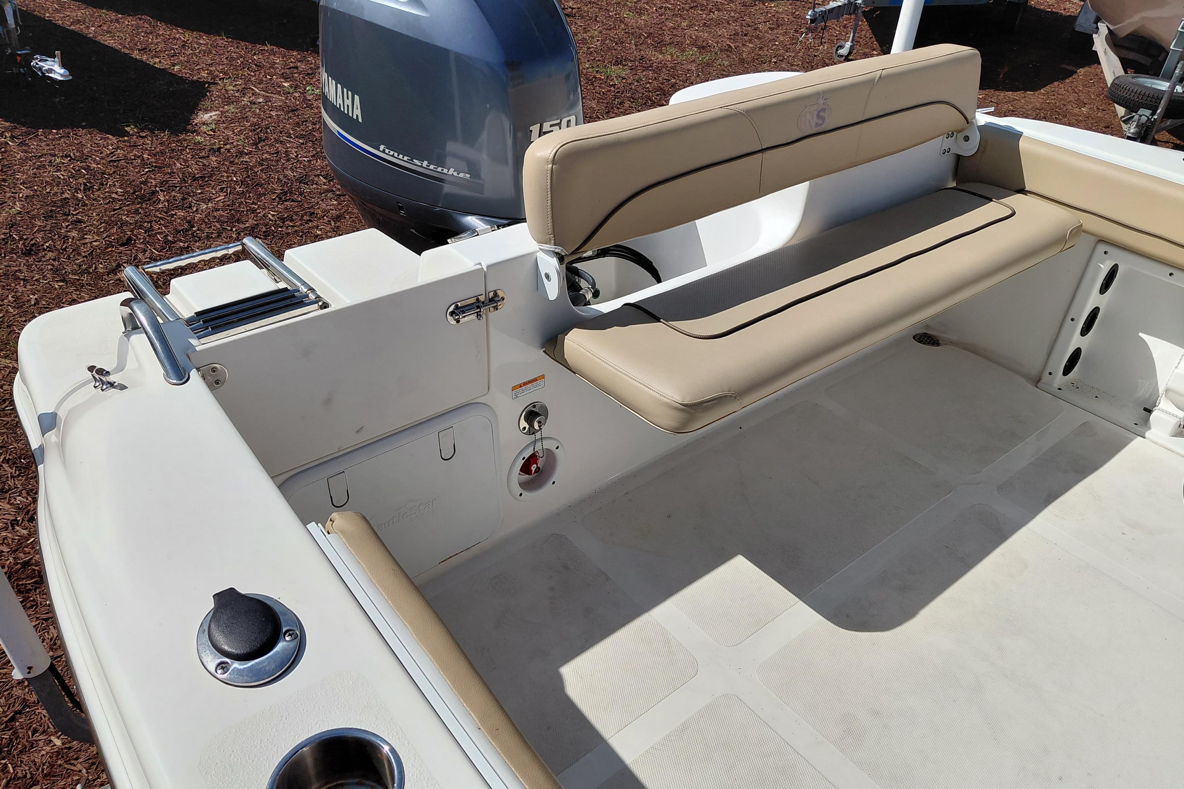 2020 NauticStar 20 XS boat interior with Yamaha engine and beige seating.