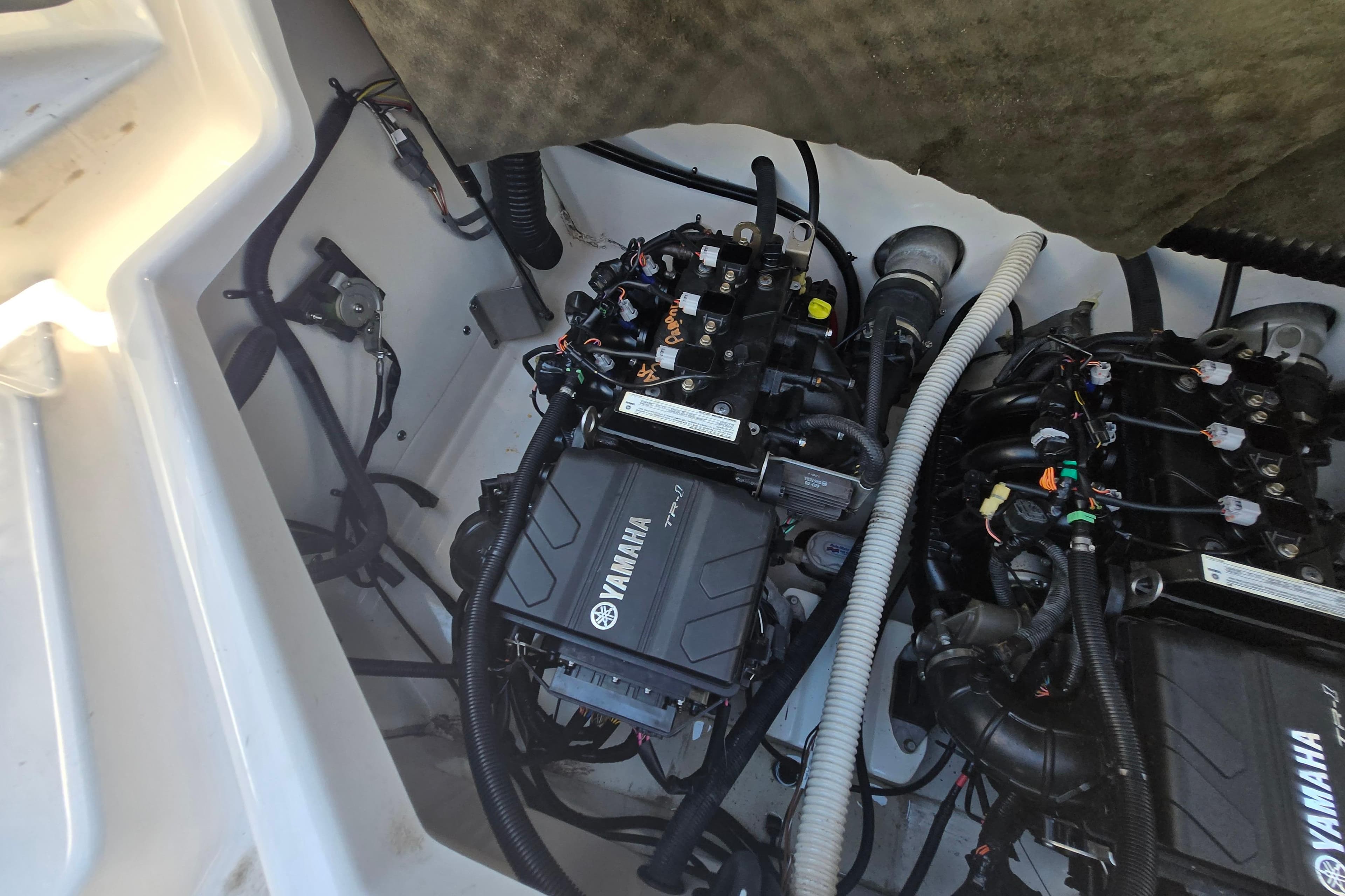 Engine compartment of a 2018 Yamaha Boats AR210, showcasing dual Yamaha engines.