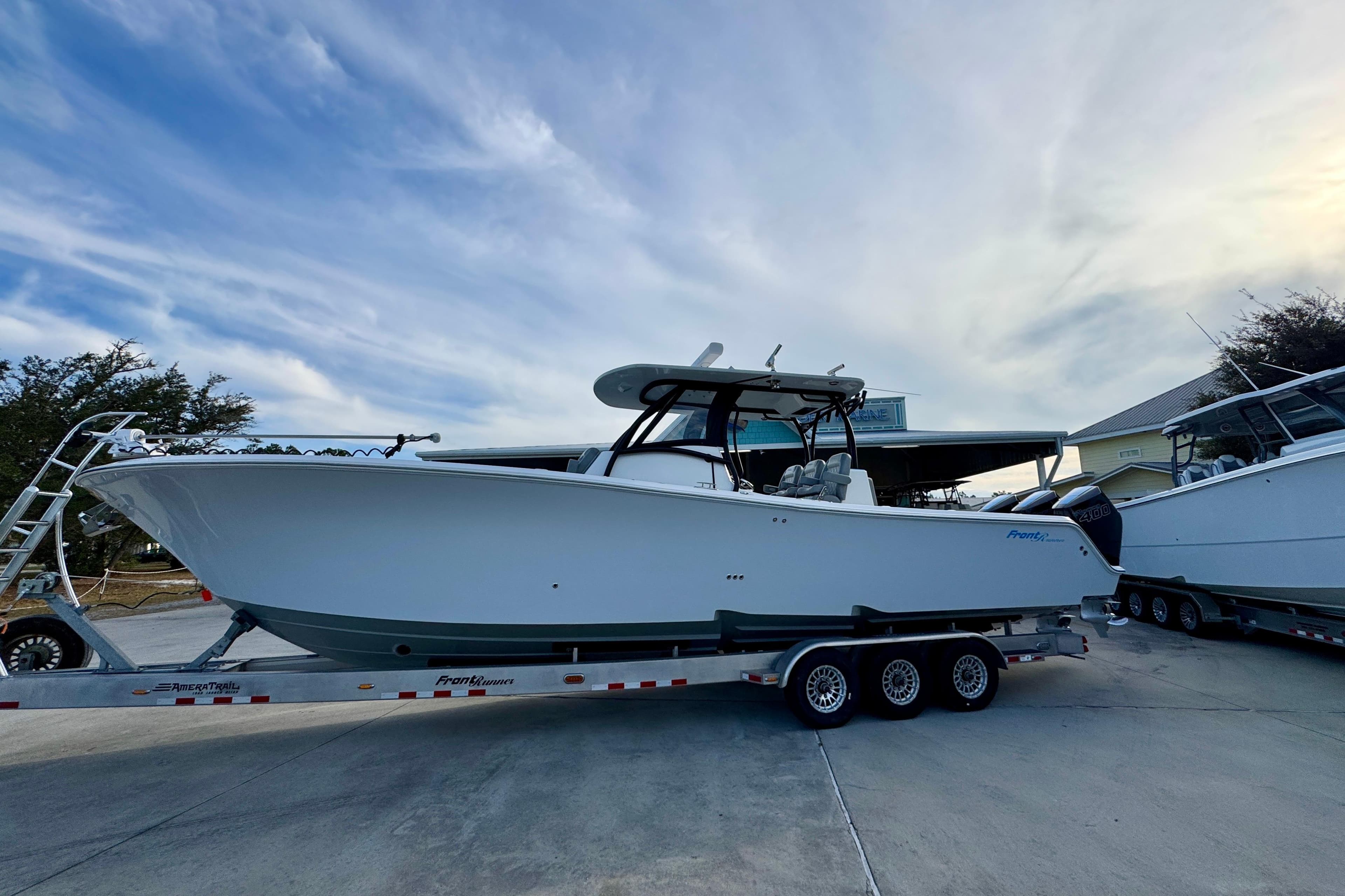 2023 Front Runner 36 Center Console boat on trailer under a cloudy sky.