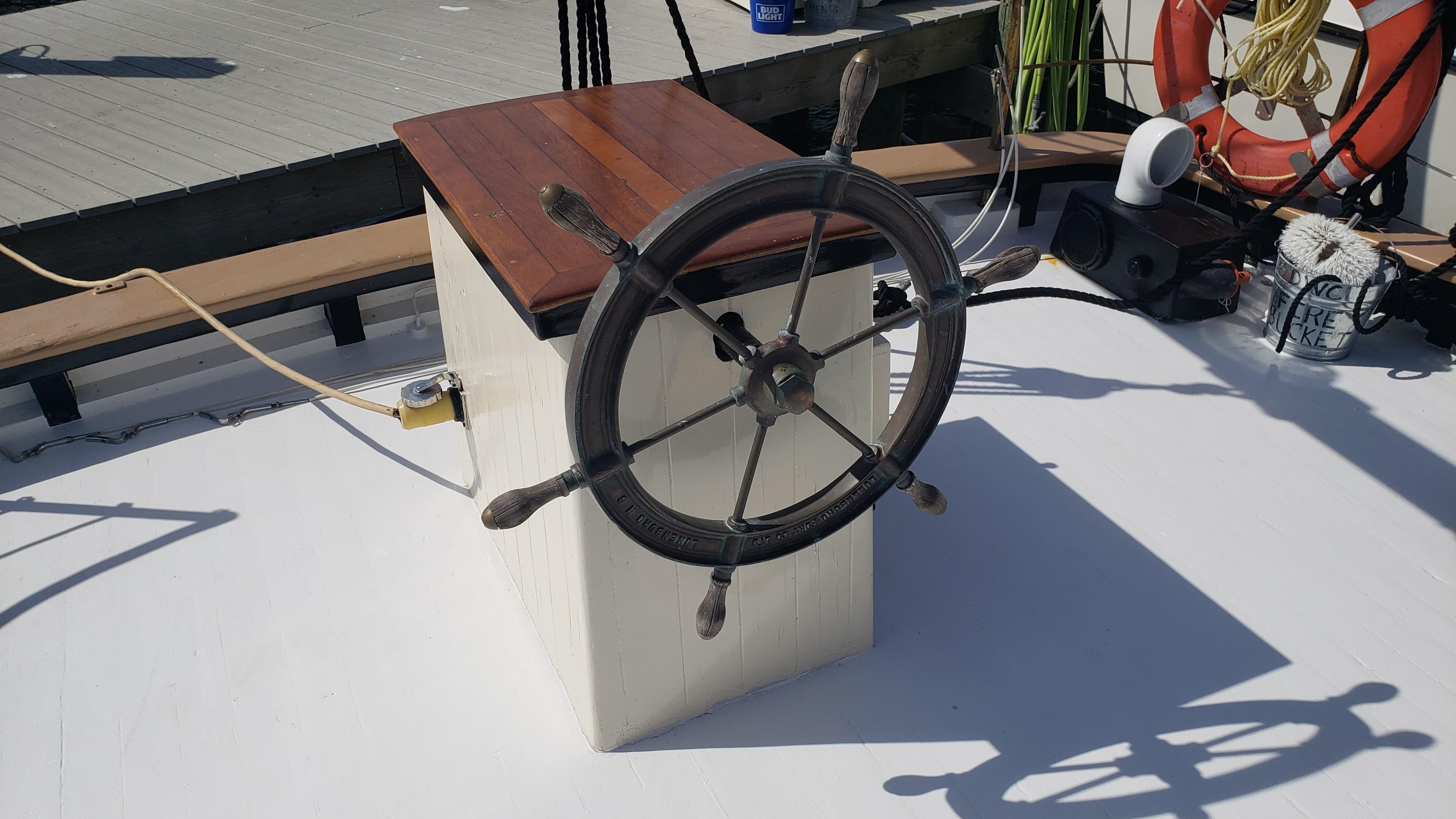 Steering wheel of a 1996 Custom Biloxi Schooner on deck.