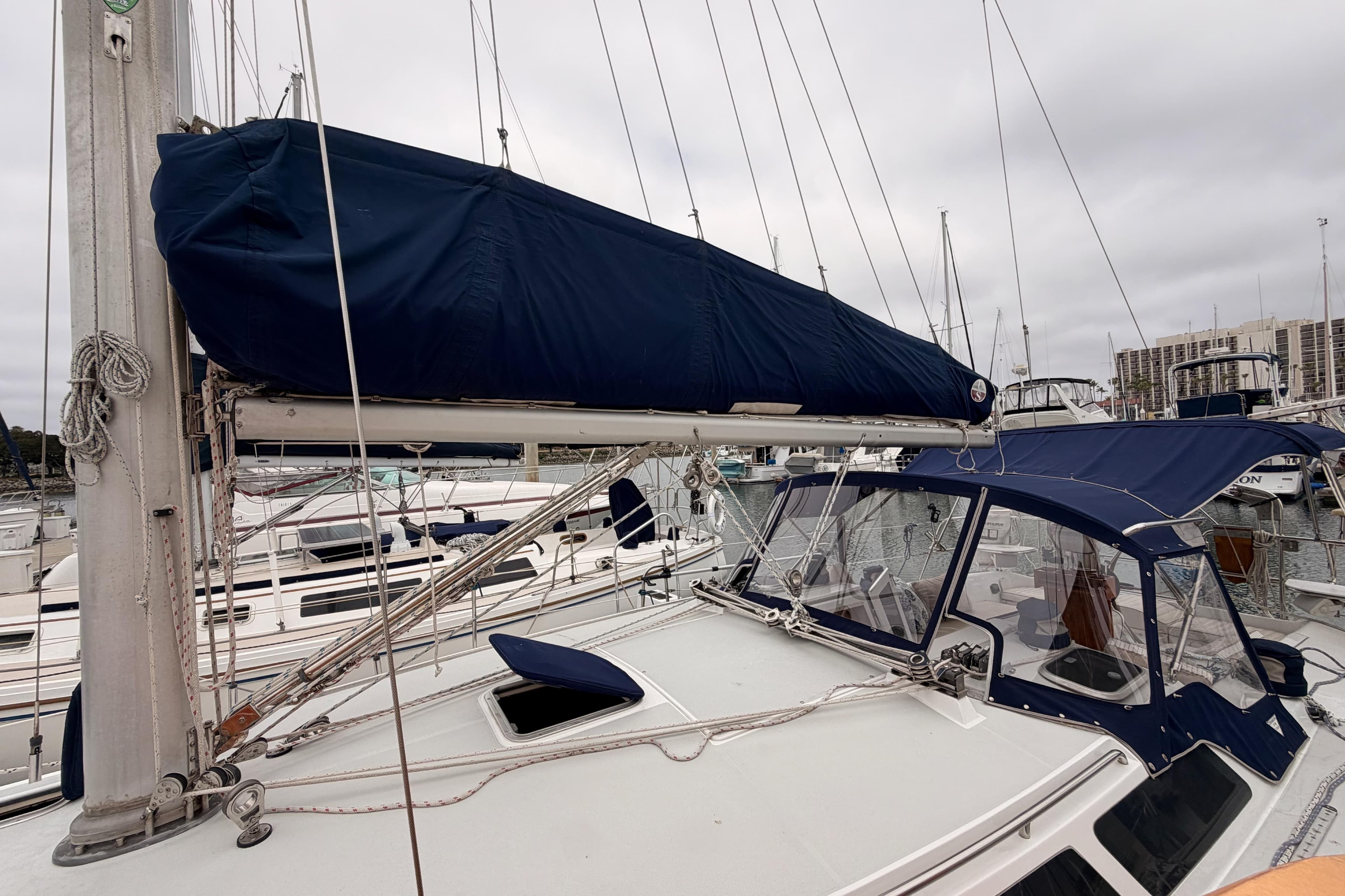 1996 Catalina 36 MkII sailboat with blue canvas cover docked at marina.