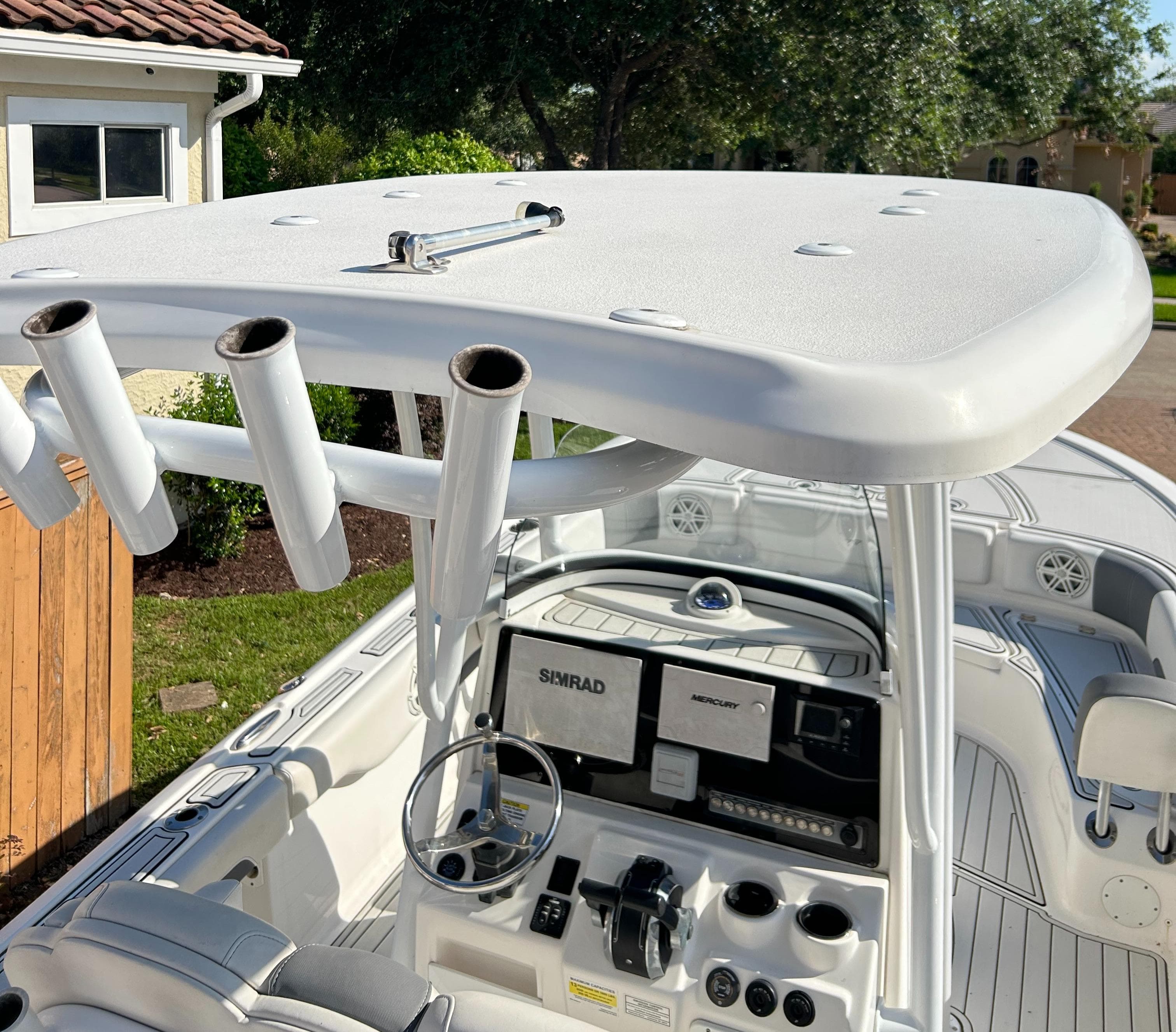 2018 Tidewater 2700 Carolina Bay boat interior with helm, rod holders, and navigation equipment.